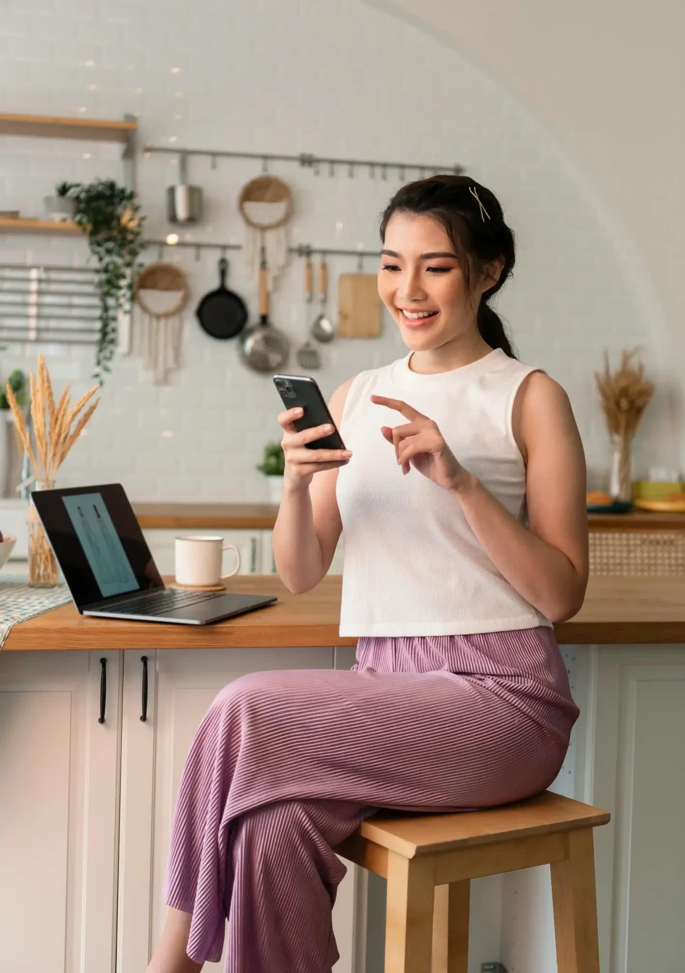 Home services owner checking Google reviews on her phone in the kitchen
