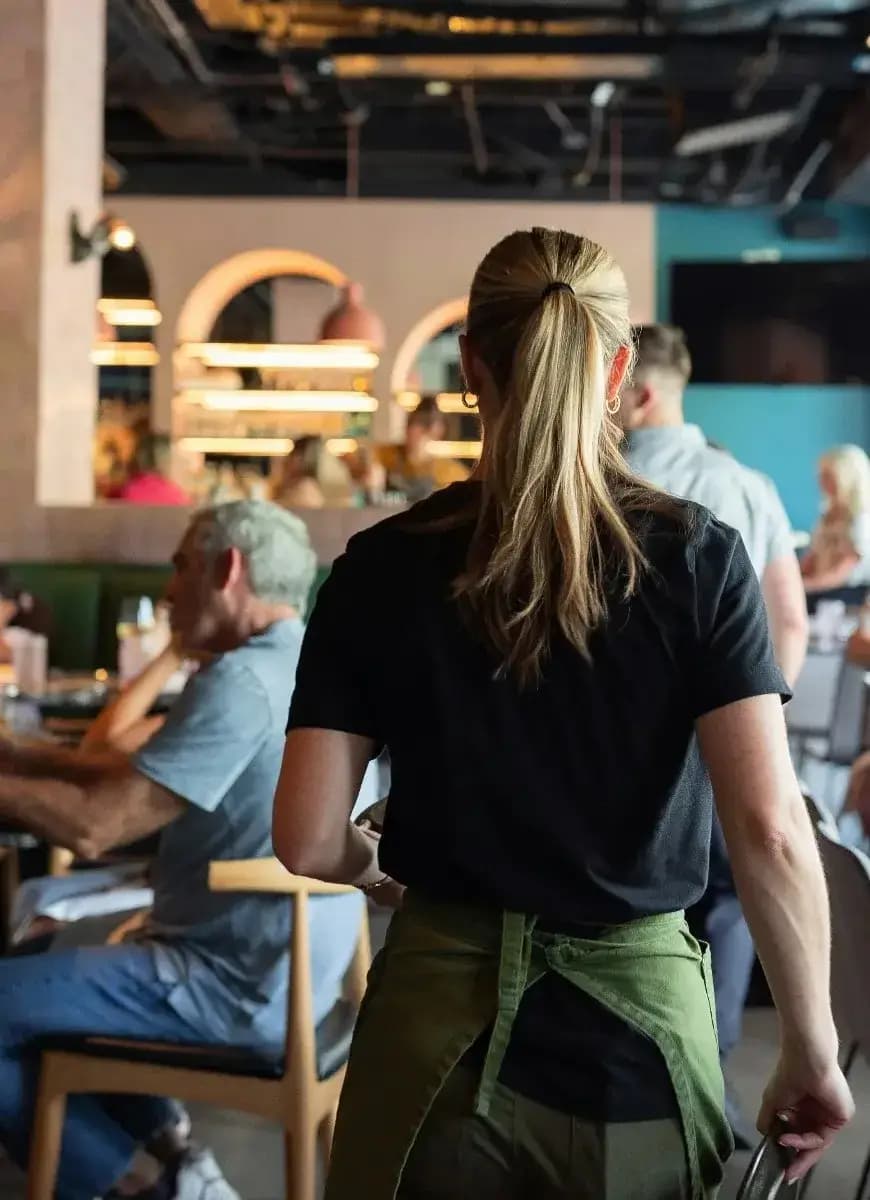 Server welcoming guests in a restaurant