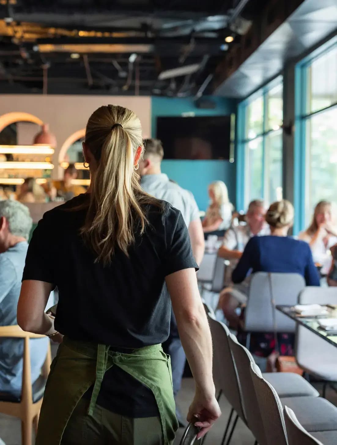 Server welcoming guests in a restaurant