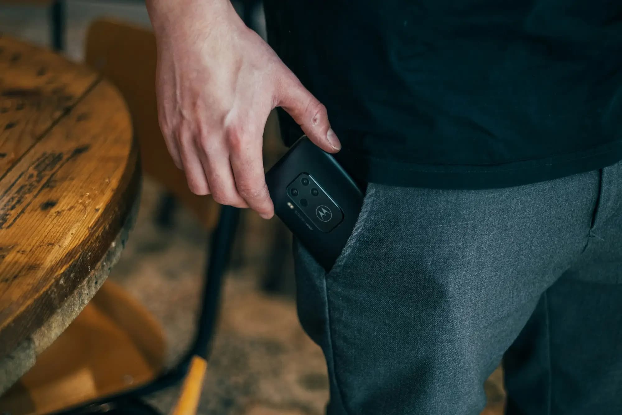 Restaurant owner taking their phone from a pocket to respond to guest feedback