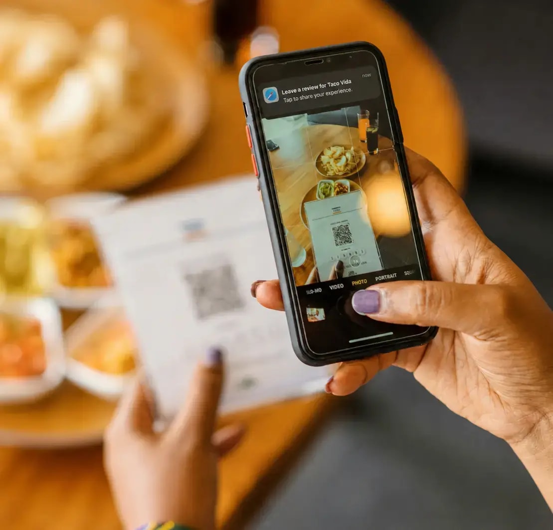 Guest scanning a Dishcus QR code to leave a Google review
