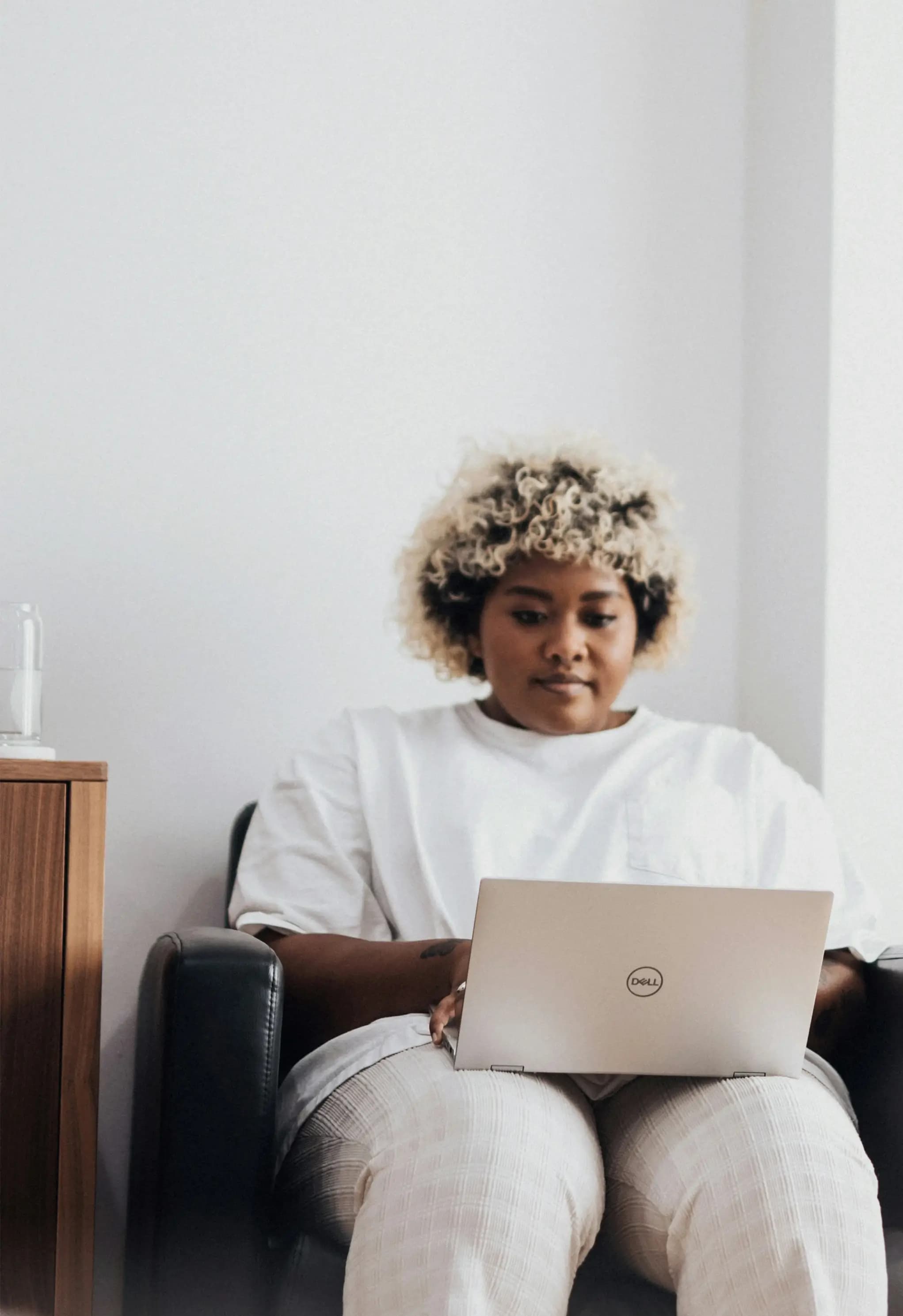 Clinic staff member working on a laptop