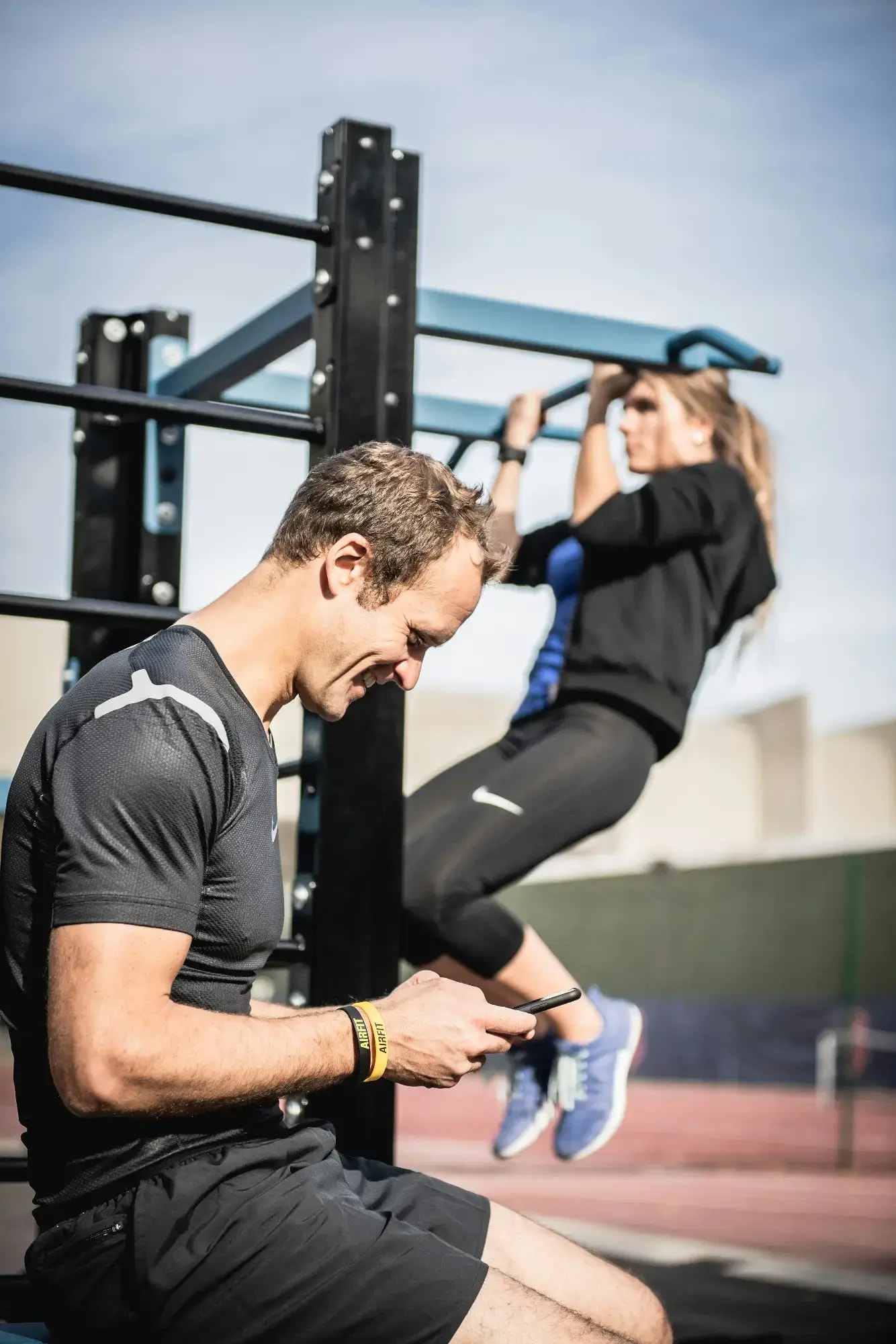 Personal trainer checking Google reviews on her phone at the studio