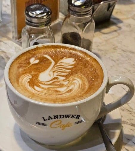Cafe Landwer team reviewing guest feedback and Google reviews together at the front of house