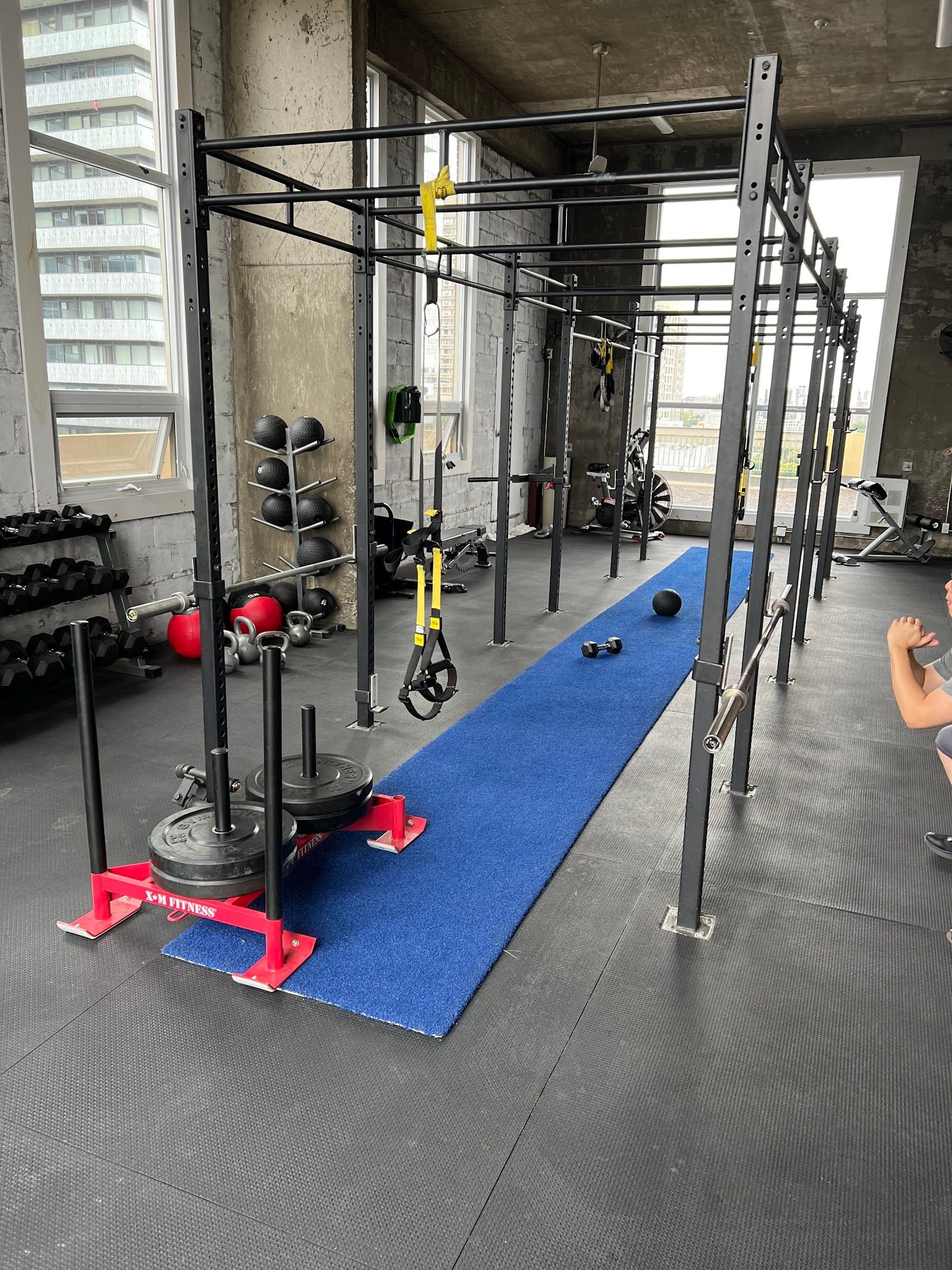 Personal trainer checking Google reviews on her phone at the studio