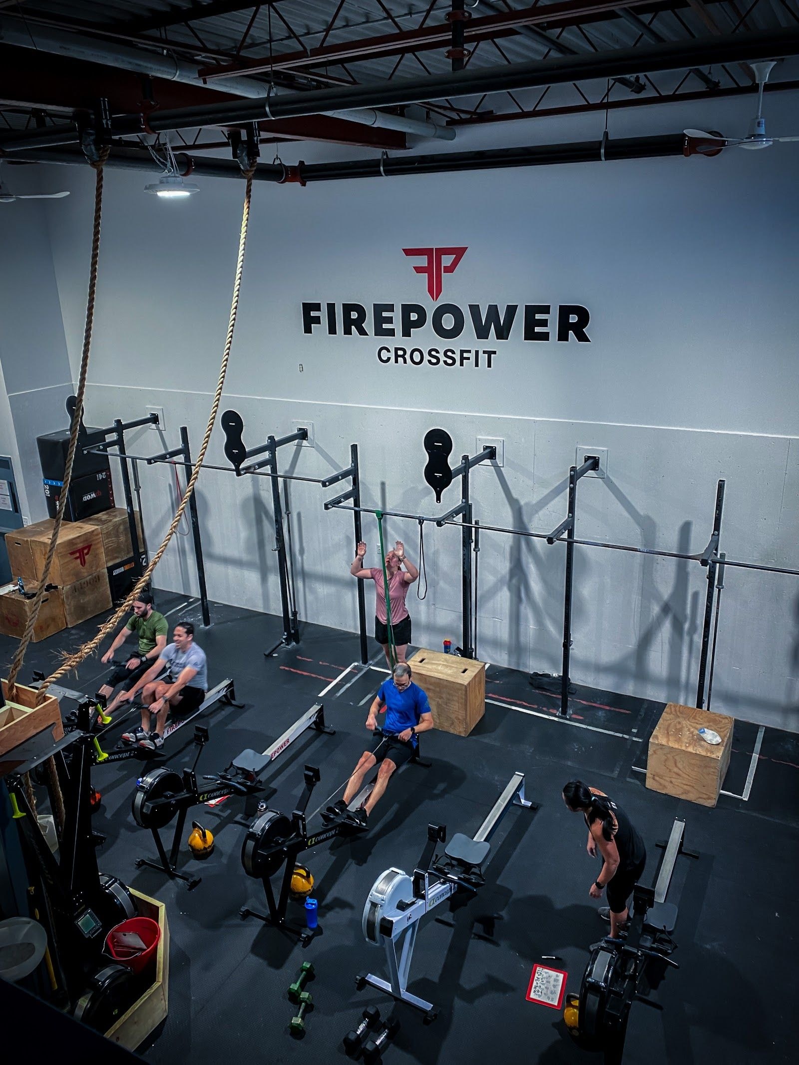 Personal trainer checking Google reviews on her phone at the studio