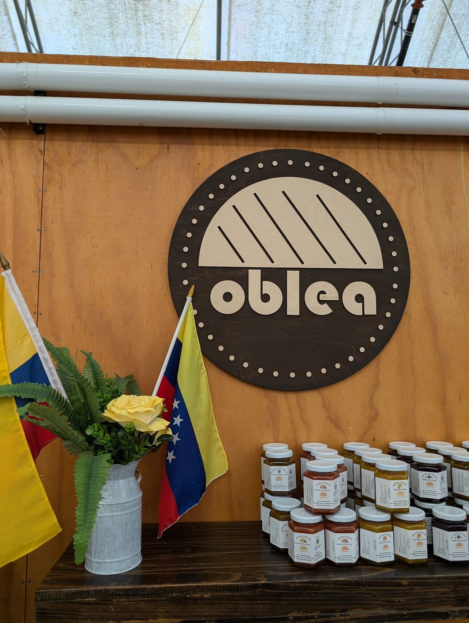 Oblea team at St. Jacobs Market reviewing guest feedback and Google reviews on a tablet at their food stand