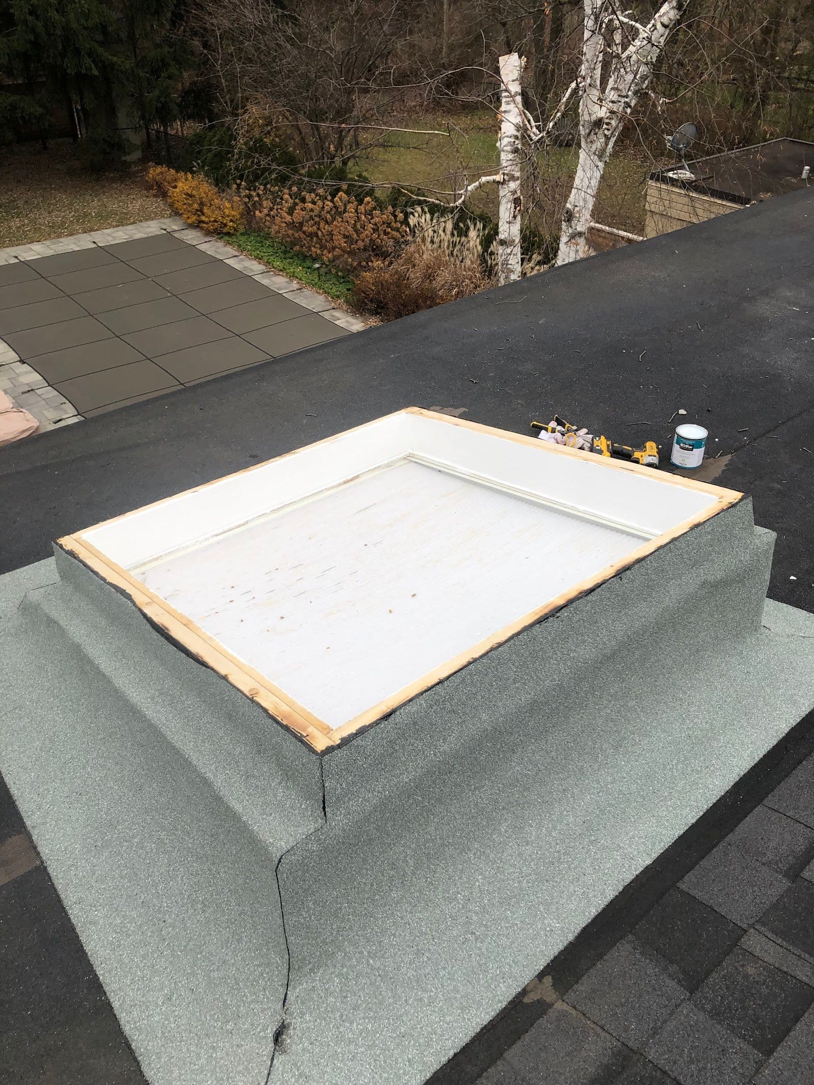 Flat Roofs Toronto owner and crew member reviewing customer feedback on a tablet at a completed flat roof job site in Toronto