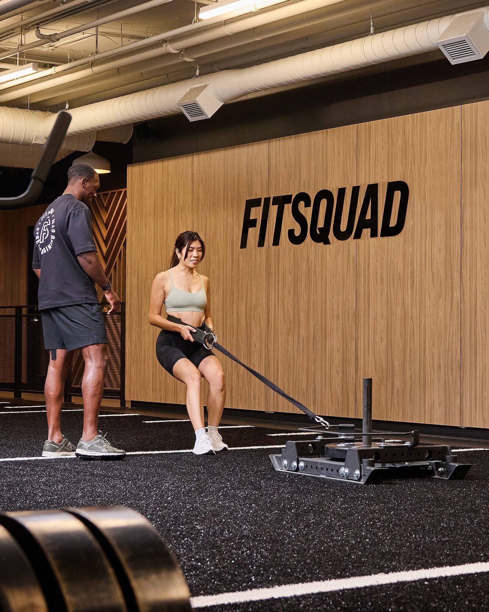 Personal trainer checking Google reviews on her phone at the studio