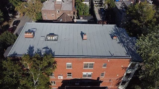 Coverall Roofing Toronto owner and manager reviewing Google customer feedback and roofing job photos on a mobile dashboard