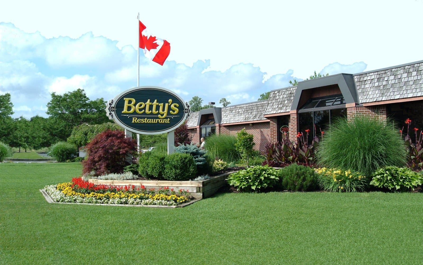 Restaurant team at Betty's Restaurant reviewing guest feedback and Google reviews together on a tablet