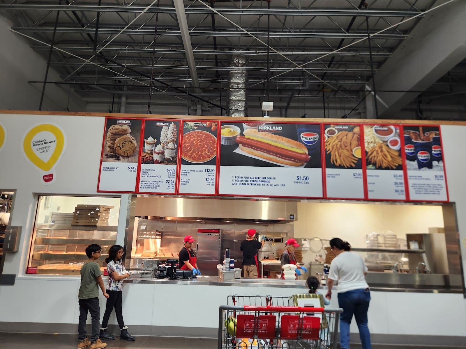 Restaurant team reviewing guest feedback and Google reviews together at Costco Food Court