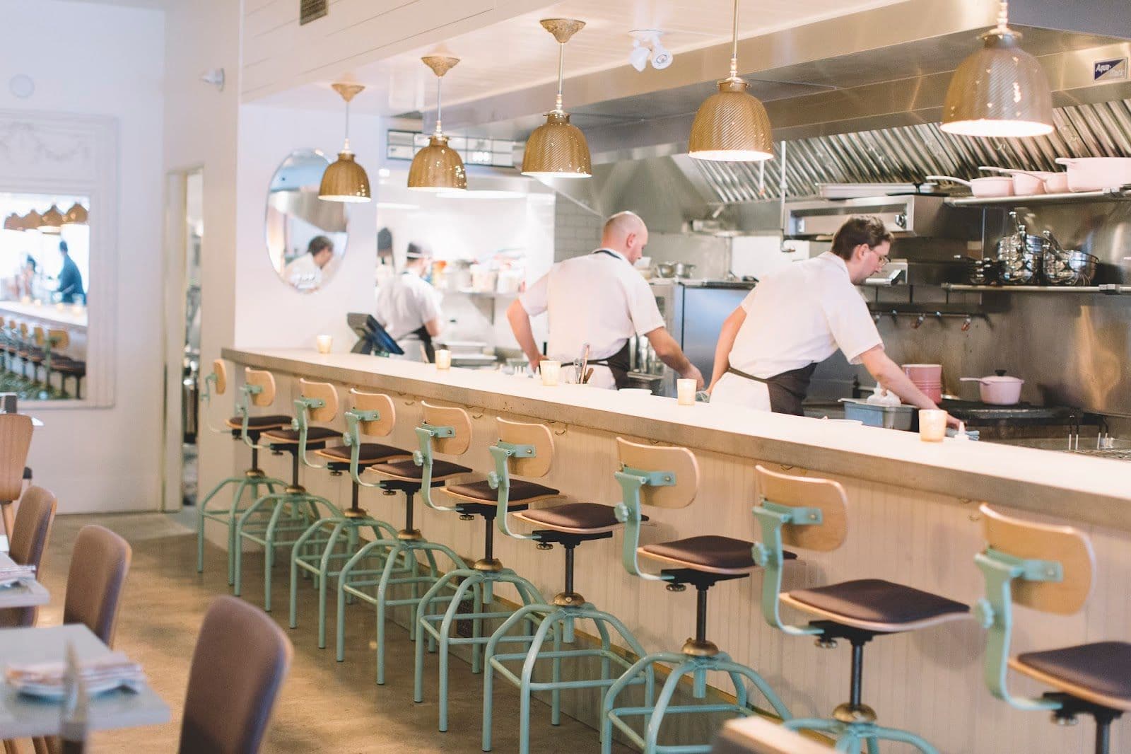 Grey Gardens restaurant team reviewing guest feedback and Google reviews together at the front of house