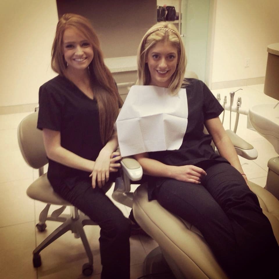 Kingwest Dental team reviewing patient feedback and Google reviews together at the front desk