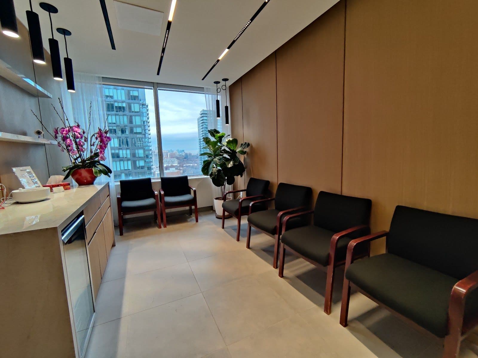 Atlas Dental team reviewing patient feedback and Google reviews together at the front desk of their Toronto dental clinic