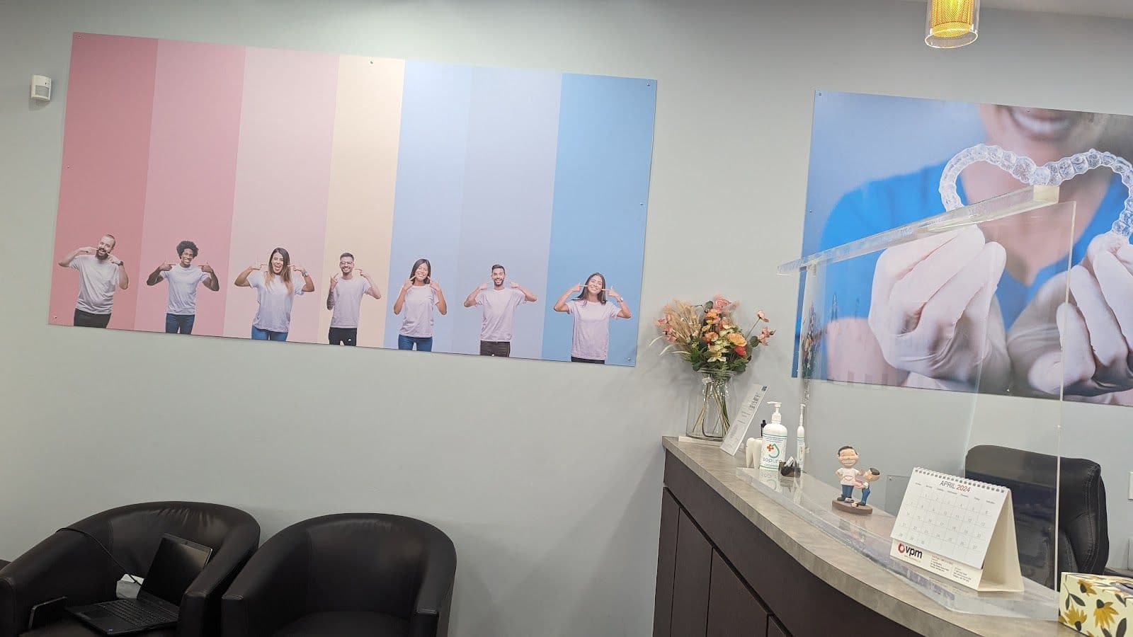 Mavis Dental Centre team reviewing patient feedback together at the front desk in Mississauga