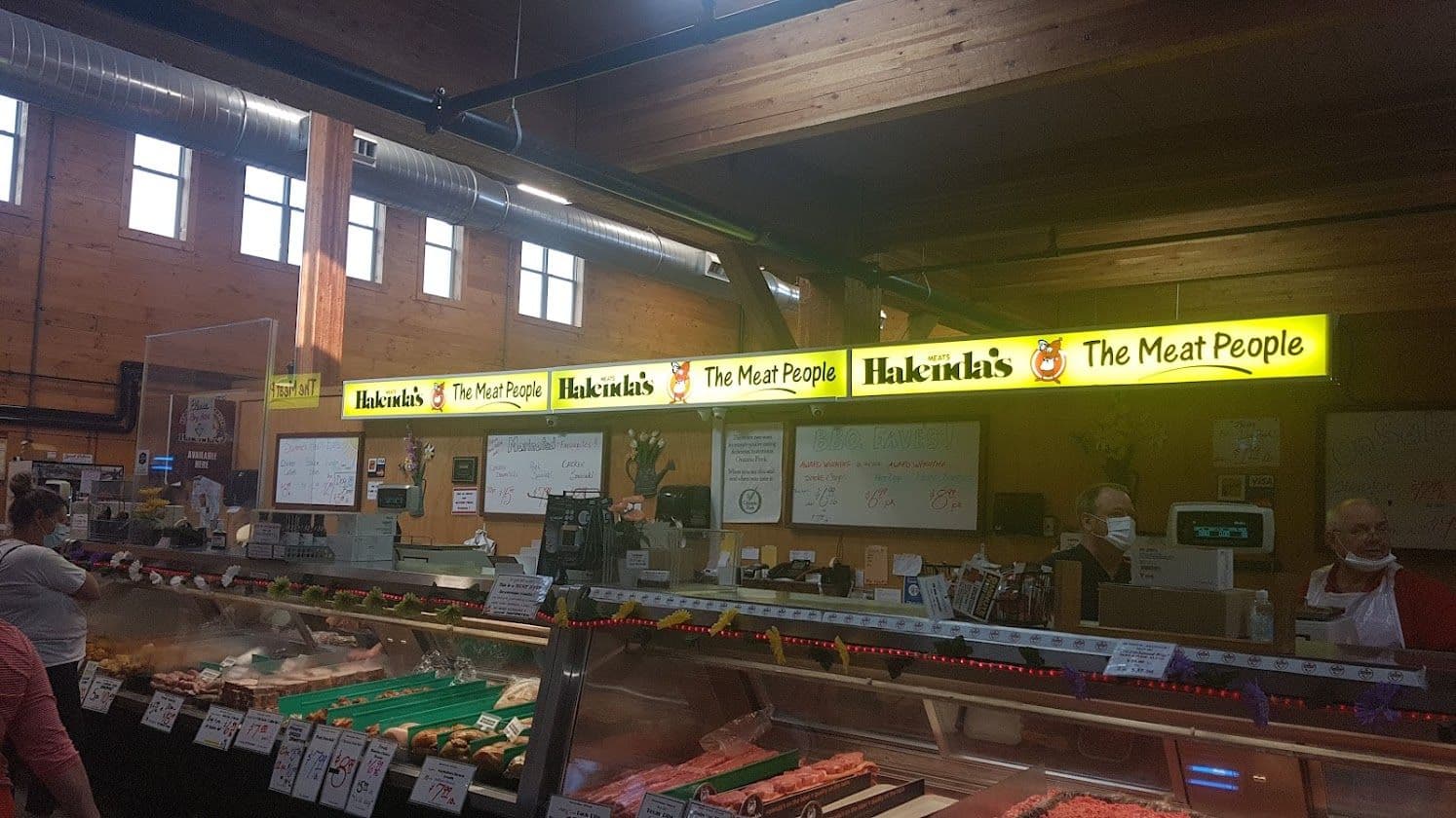 The Halenda's Meats team at St. Jacob's Farmer's Market reviewing guest feedback together at their counter