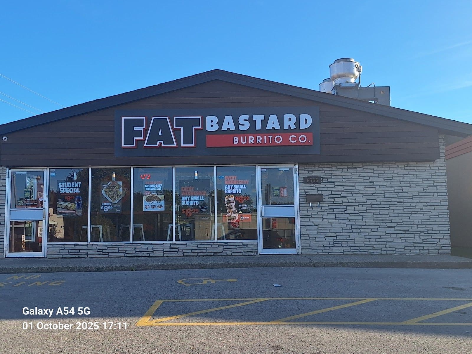 Fat Bastard Burrito team gathered around a tablet reviewing guest feedback and Google review themes in their restaurant