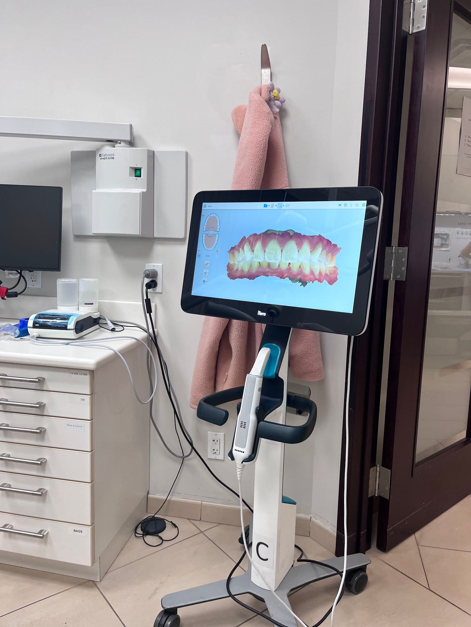 Downtown Dentistry team reviewing patient feedback on a tablet at the front desk of their dental clinic