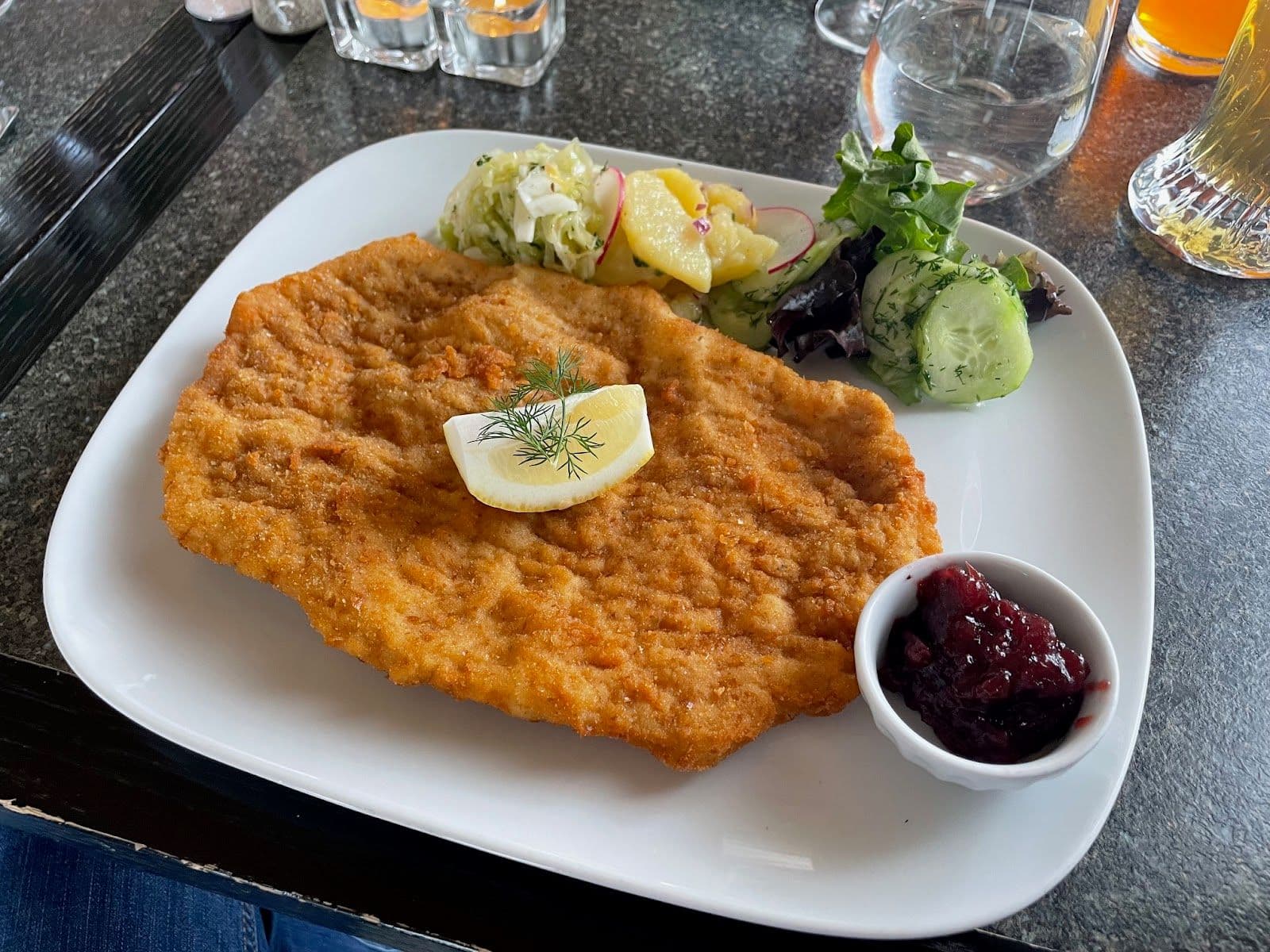 Owner and front-of-house team at Wiener Schnitzel Haus reviewing Google guest feedback together on a tablet