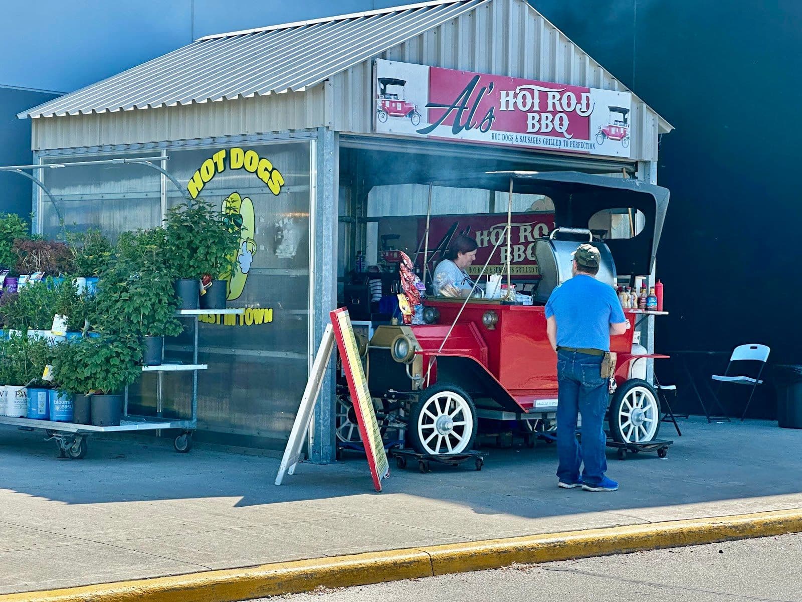 Al's Hot Rod BBQ owner and team reviewing Google guest feedback on a tablet at their outdoor cart setup