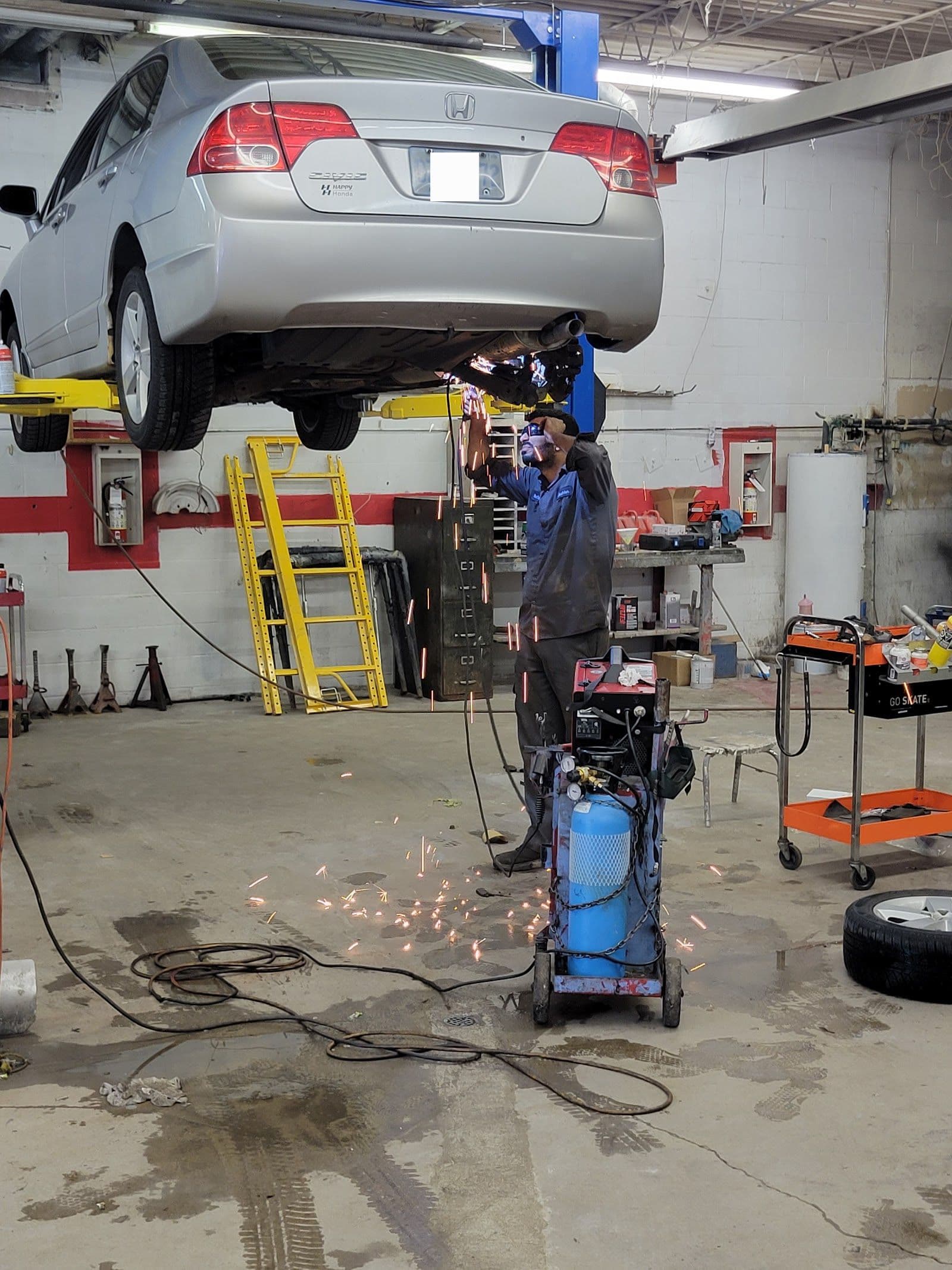 QUICK FIX AUTO team reviewing customer feedback and Google reviews together at the shop front desk