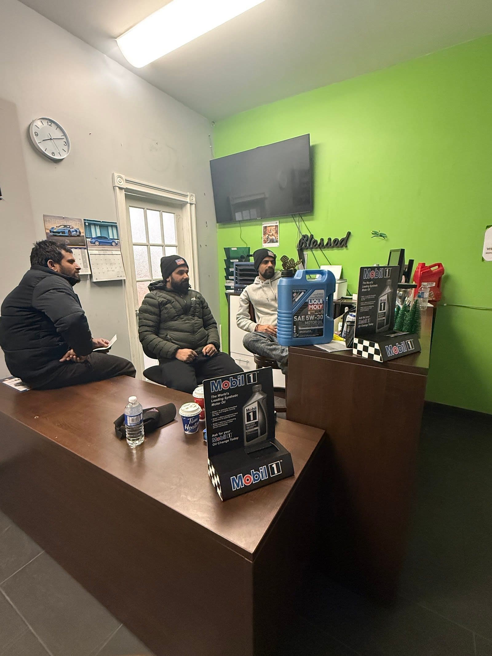 Brother's Auto Care owner and service staff reviewing customer feedback together at their London auto care location