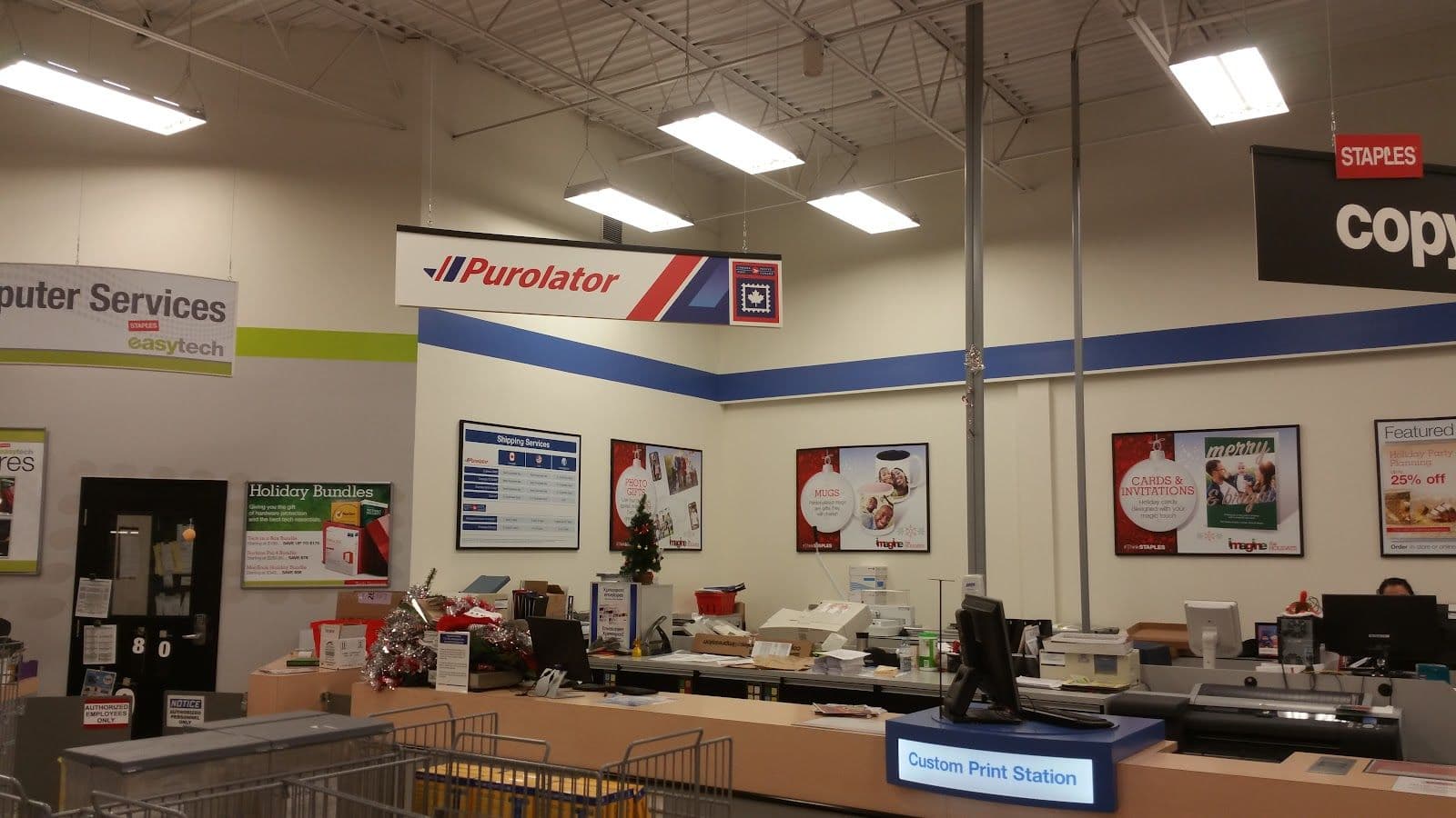 Staples store manager reviewing customer feedback and Google review themes on a dashboard at the service desk