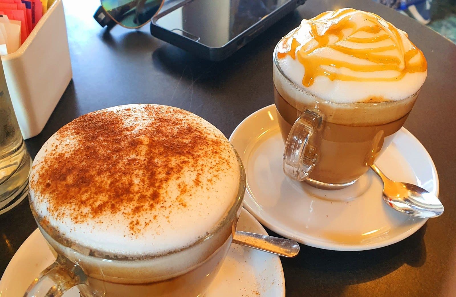 Owner and staff at Mr. Cappuccino Ice Cream, Coffee Bar and Bistro reviewing guest feedback together at the counter