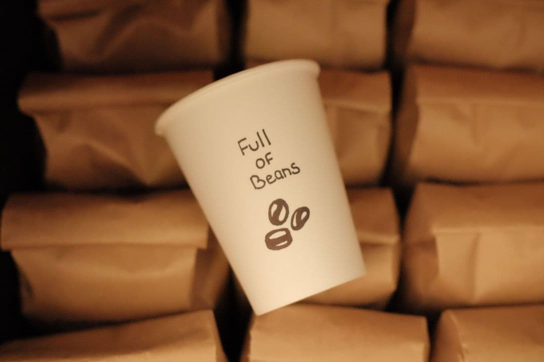 Full of Beans Coffee Co owner and staff reviewing Google guest feedback together at their St. Jacobs market coffee counter