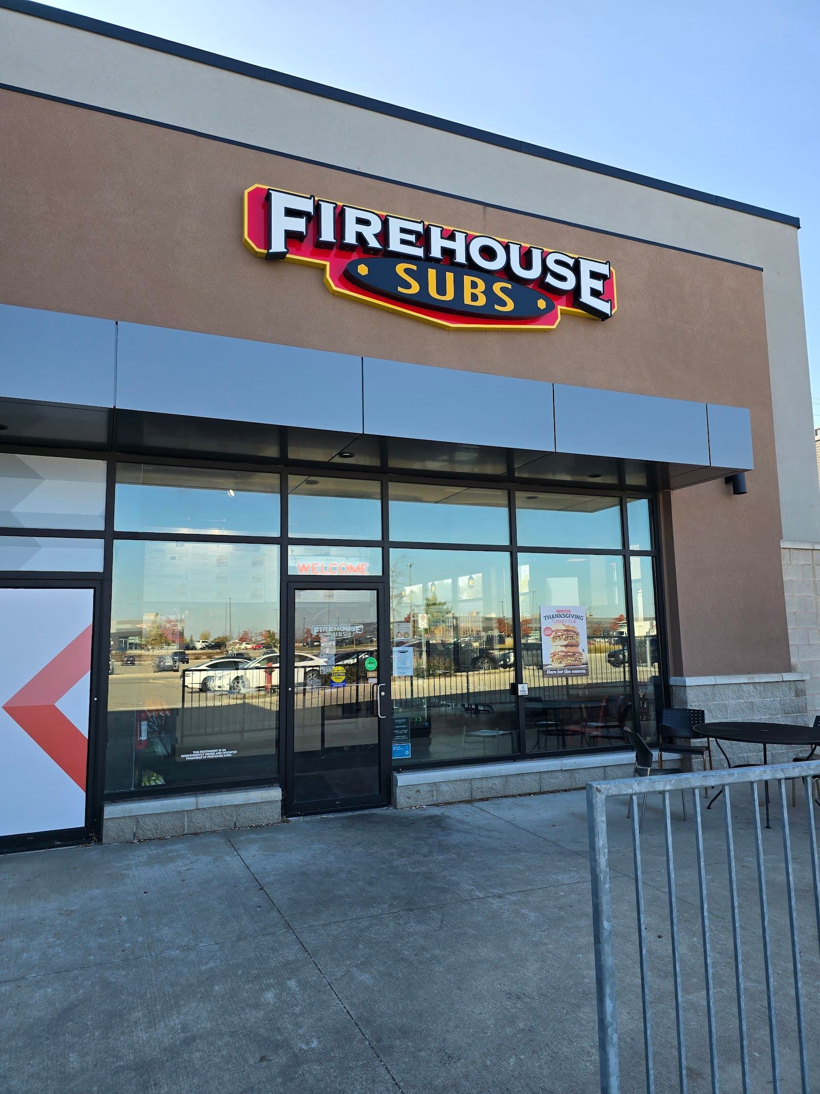 Restaurant team at Firehouse Subs Waterloo Weber St. reviewing guest feedback together on a tablet at the counter.