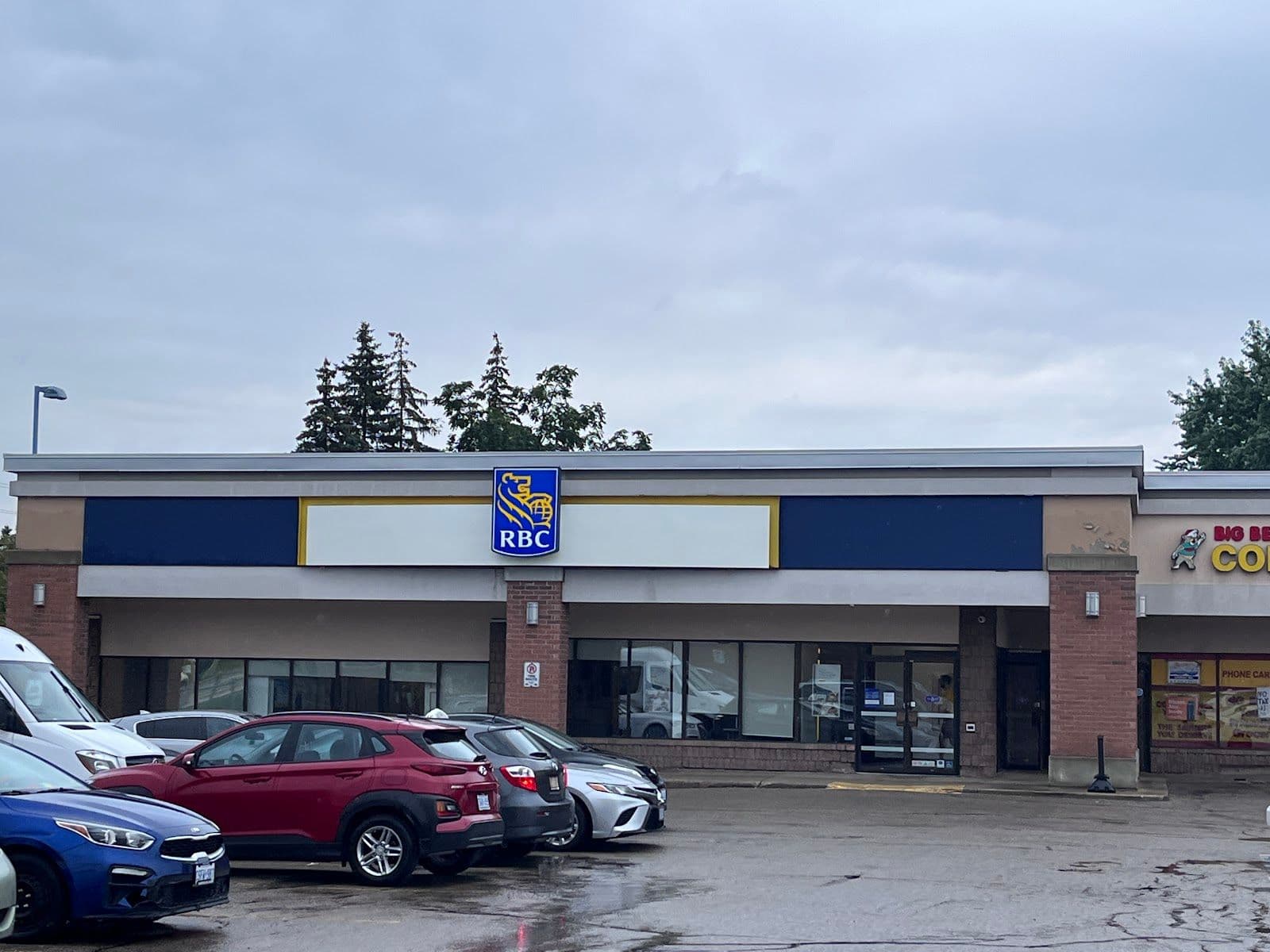 Branch manager and team at RBC Royal Bank Northfield reviewing guest feedback on a tablet at the front counter