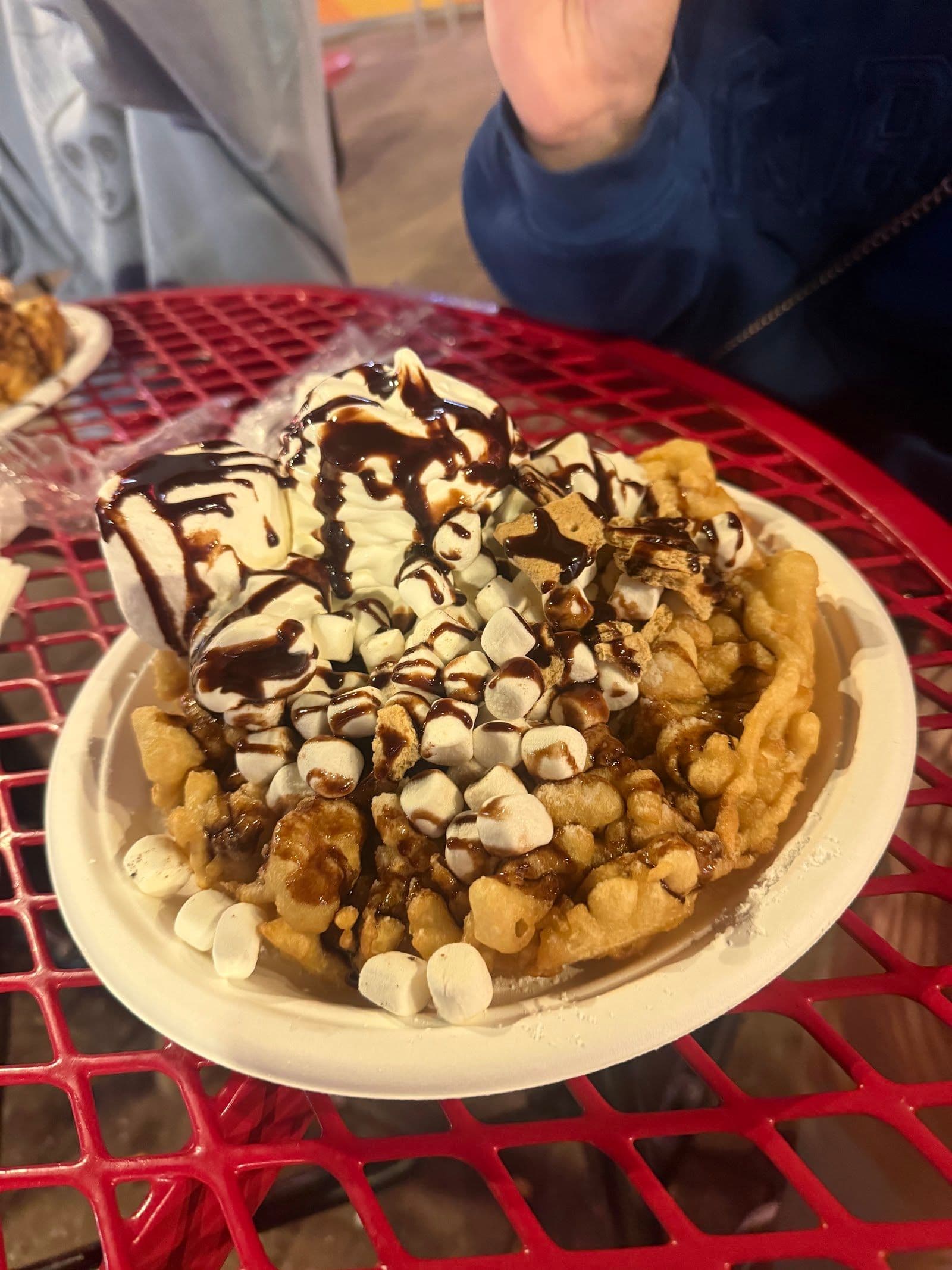 Funnel Cakes team reviewing guest feedback and Google reviews together at the counter