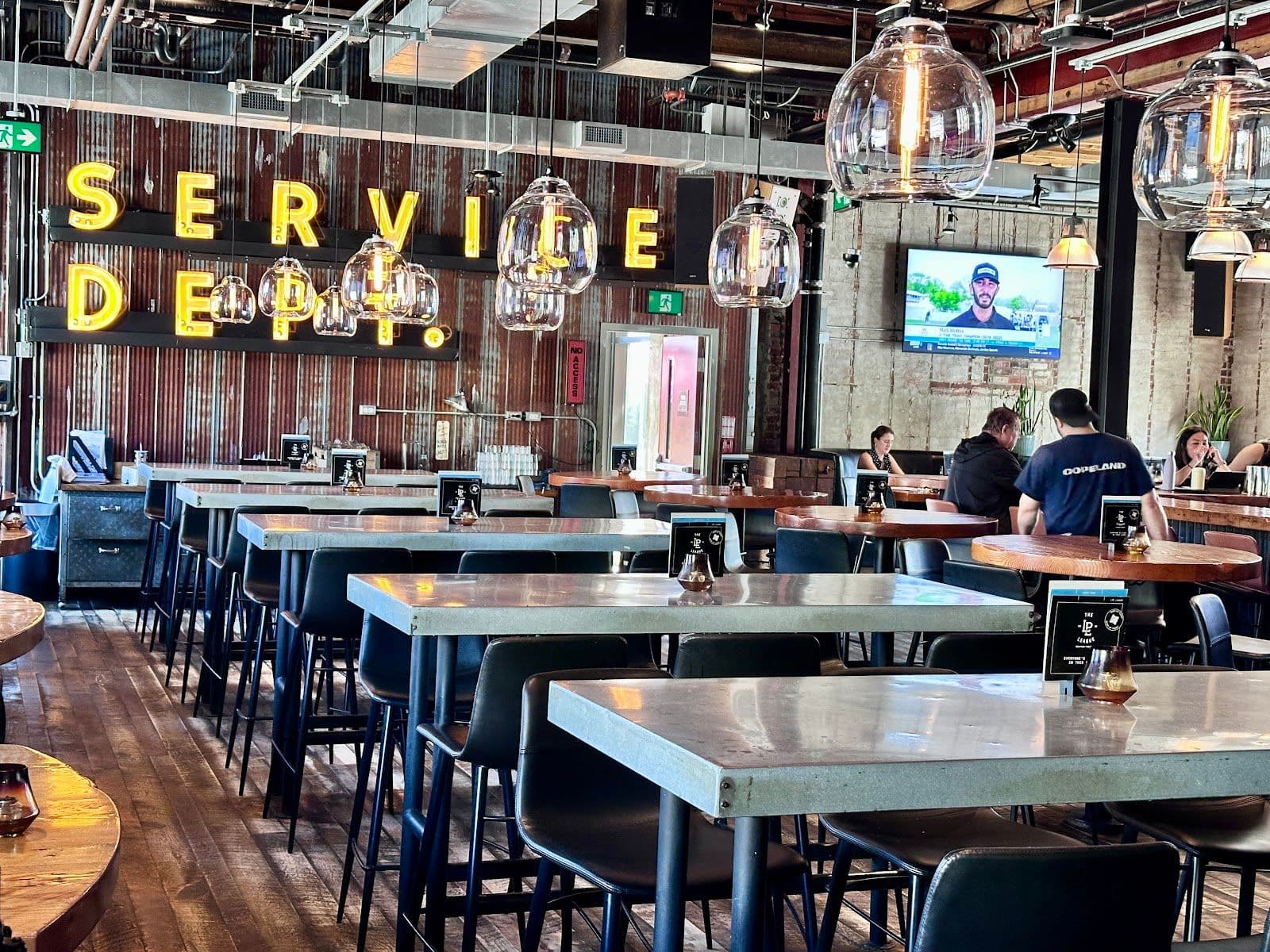 LOCAL Public Eatery Leaside team reviewing guest feedback together at the bar