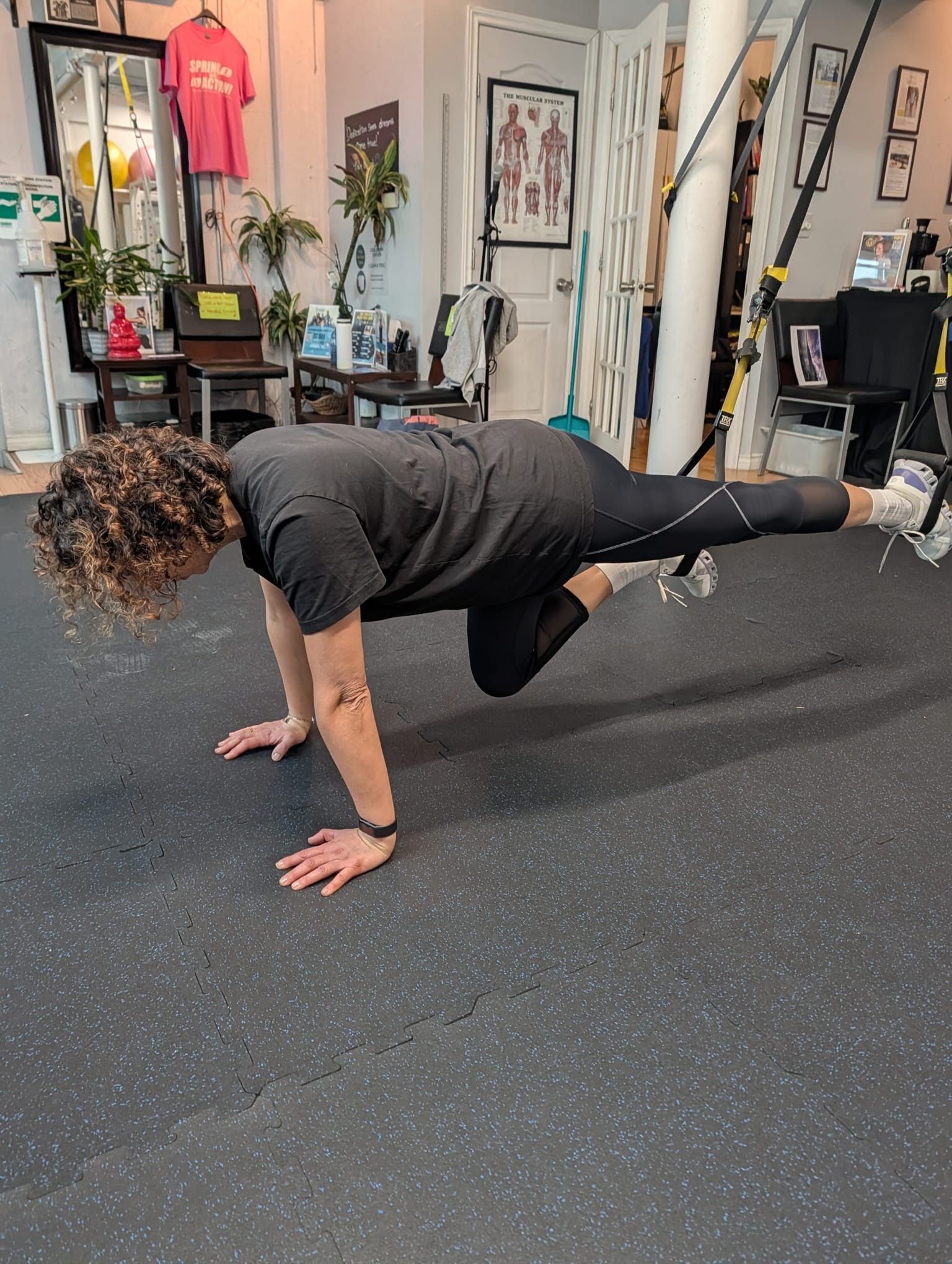 Personal trainer checking Google reviews on her phone at the studio