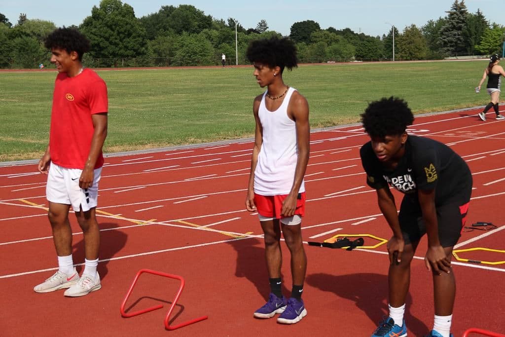 Athlete Training Ground coach and staff reviewing member feedback and Google ratings on a tablet at their Milton facility
