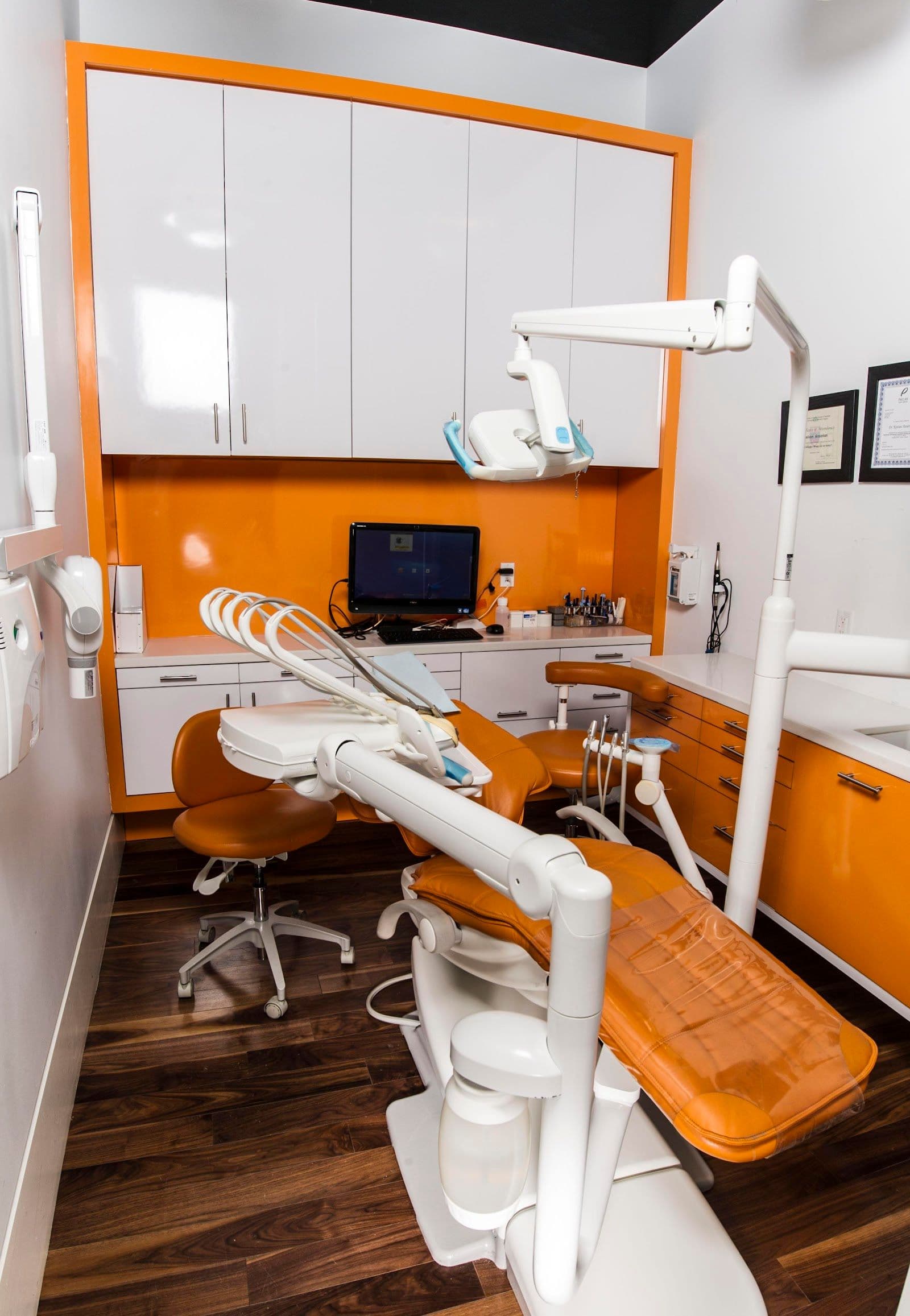 Ansarian Dental Clinic team reviewing patient feedback together at the front desk after a busy day of appointments