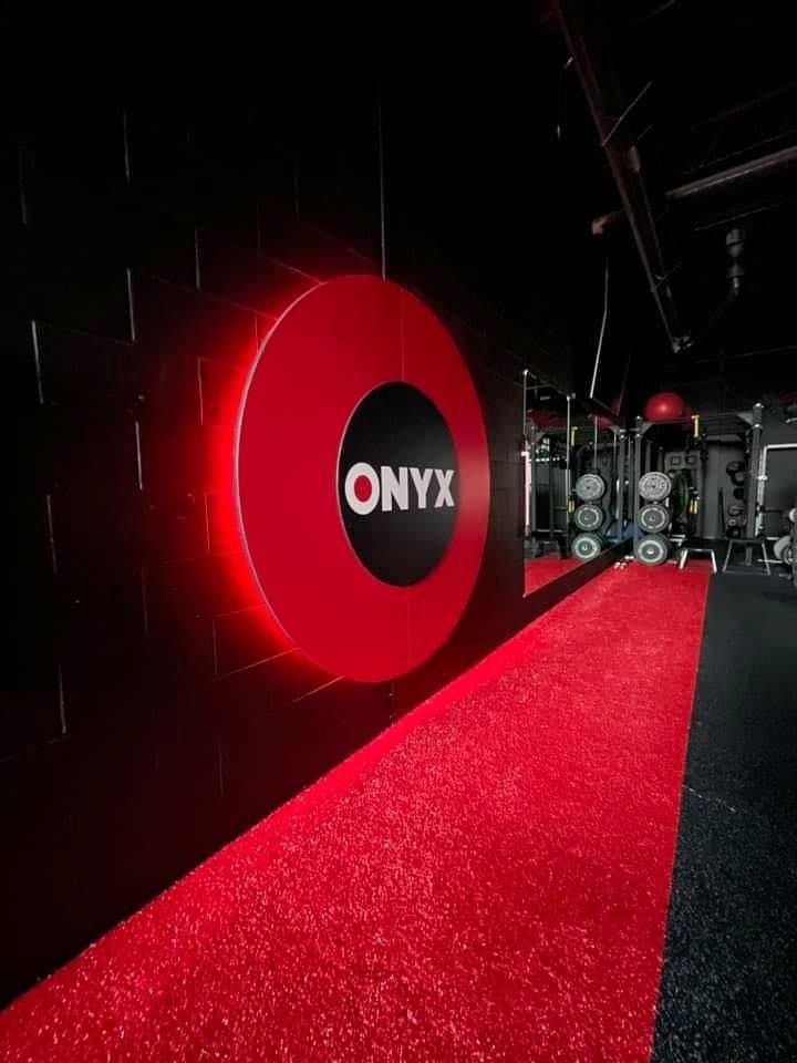 Personal trainer checking Google reviews on her phone at the studio