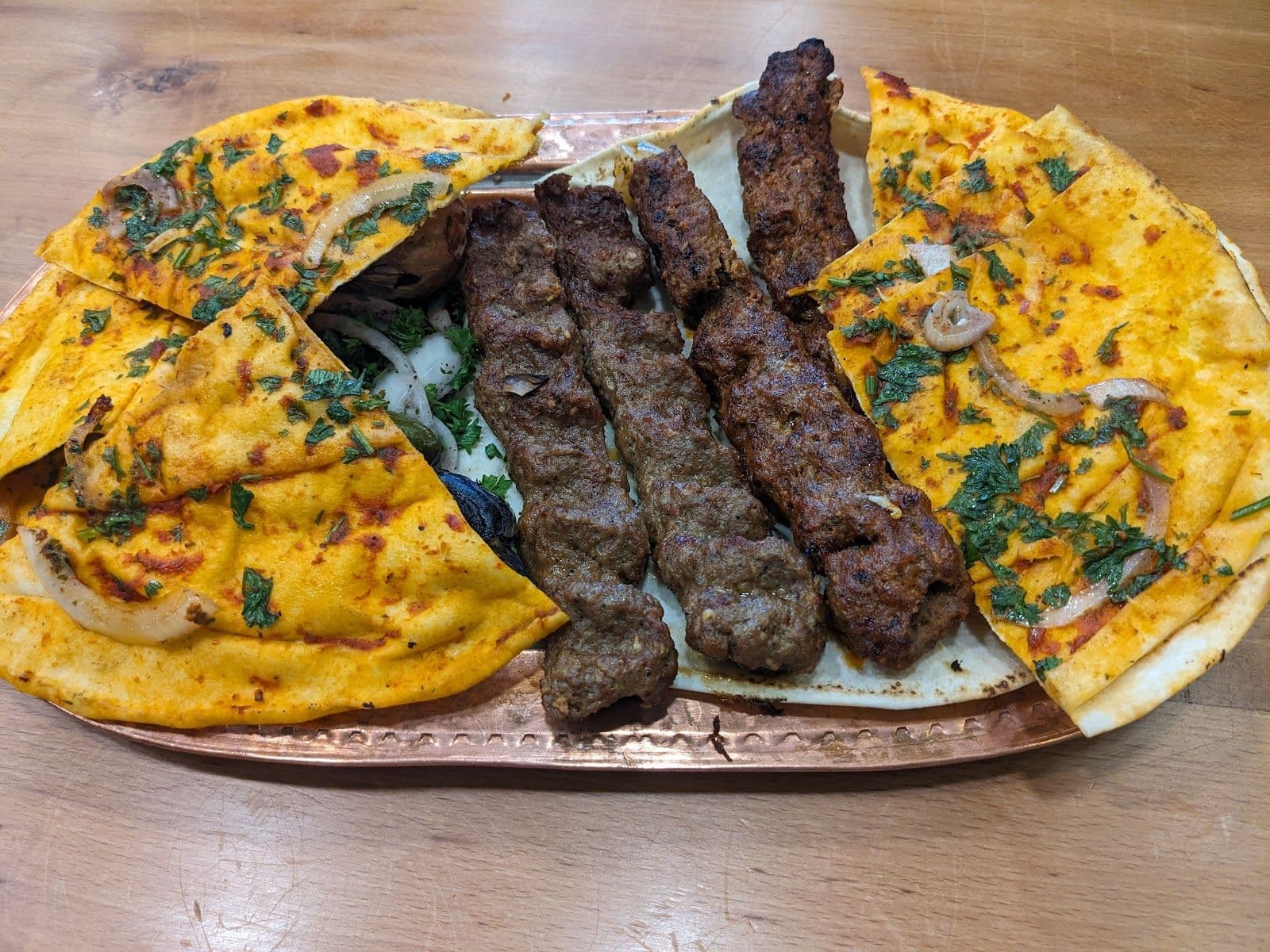 Aleppo Kebab owner and team reviewing guest feedback and Google reviews together at the restaurant