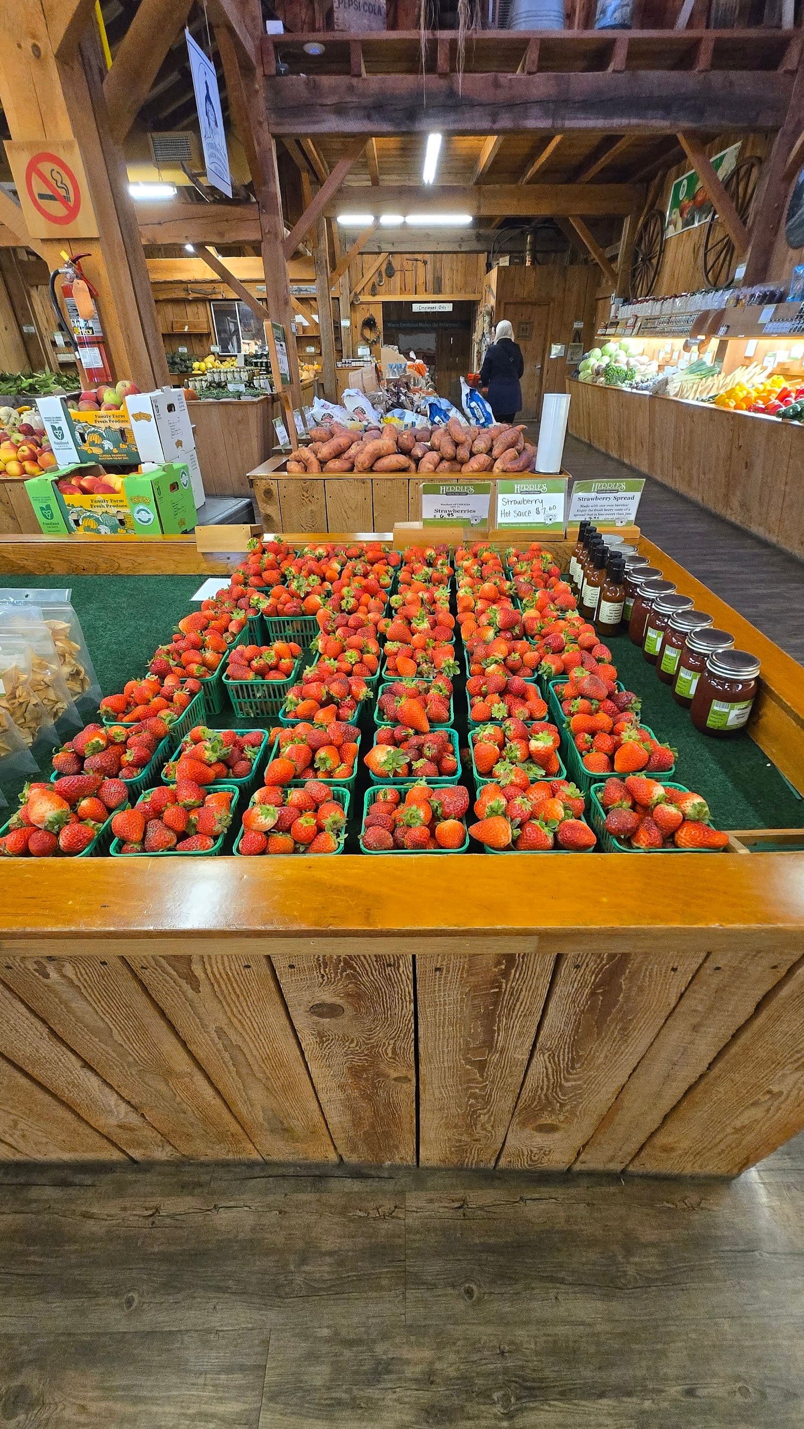Owner and team at Herrle's Country Farm Market reviewing Google guest feedback together on a tablet near the market counter