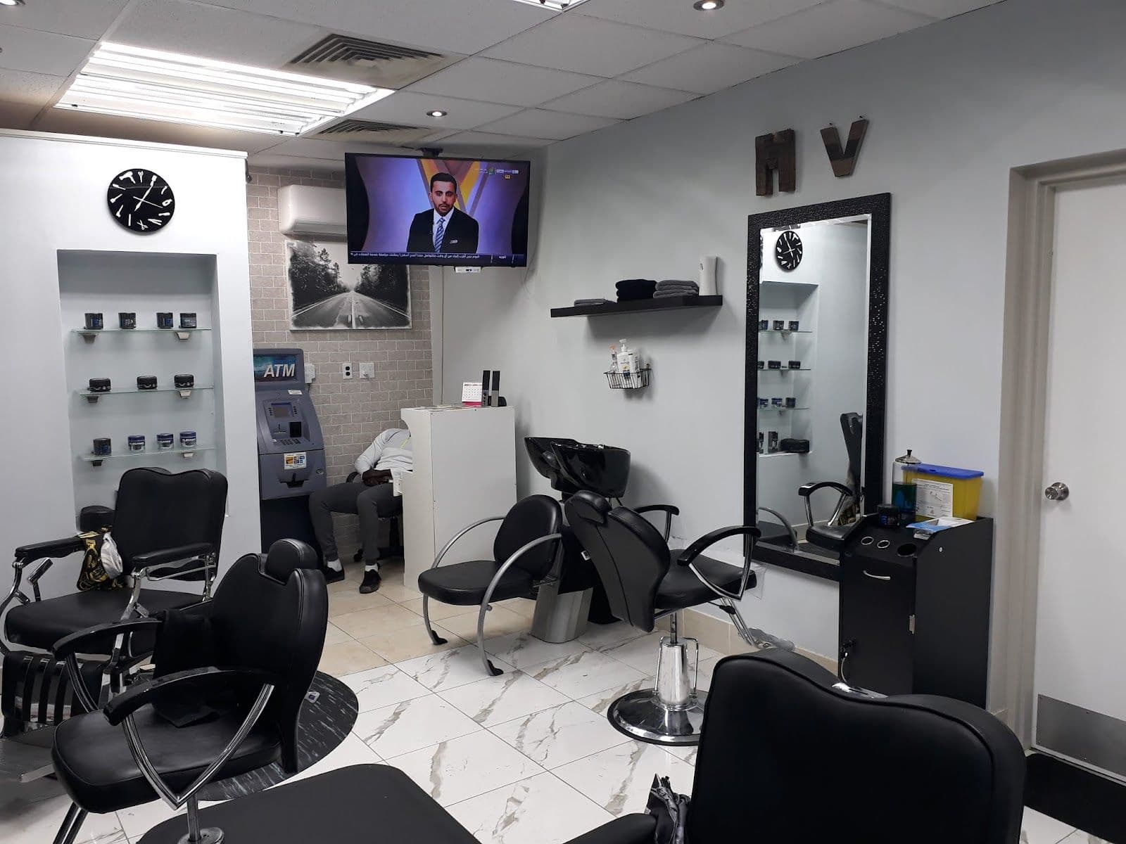 MV Barbershop owner and barbers reviewing guest feedback and Google reviews together at the shop