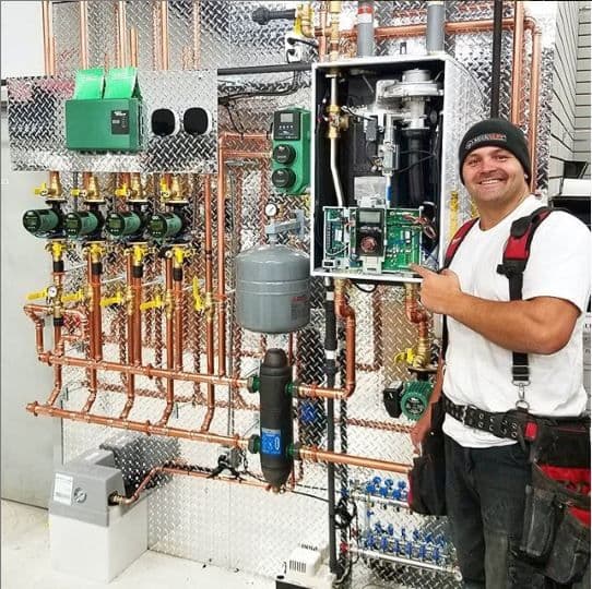 AccuServ Heating and Air Conditioning team reviewing customer feedback on a mobile dashboard after a furnace and AC installation job