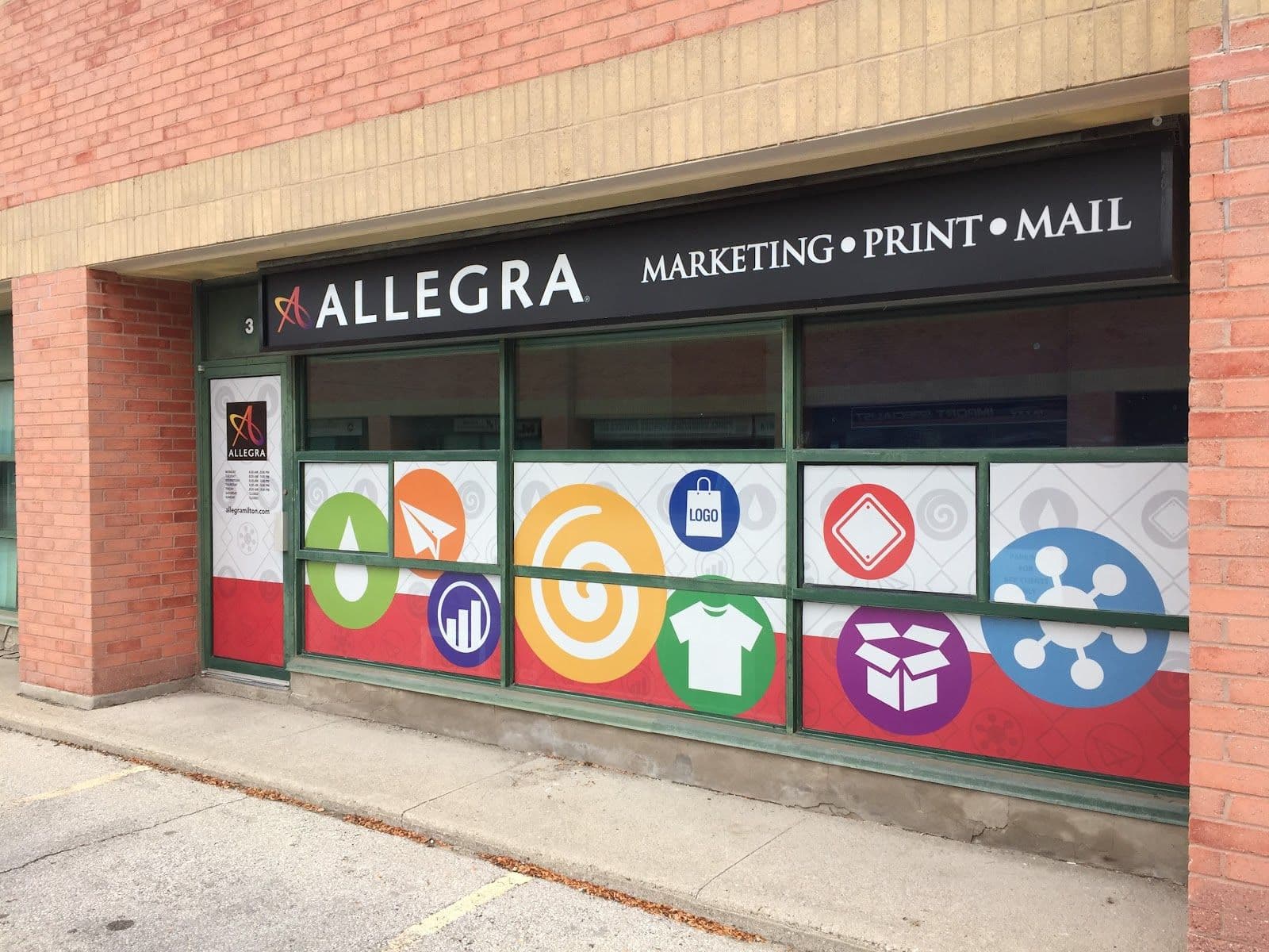 Allegra Marketing Print Mail team reviewing customer feedback and print orders at their Milton location
