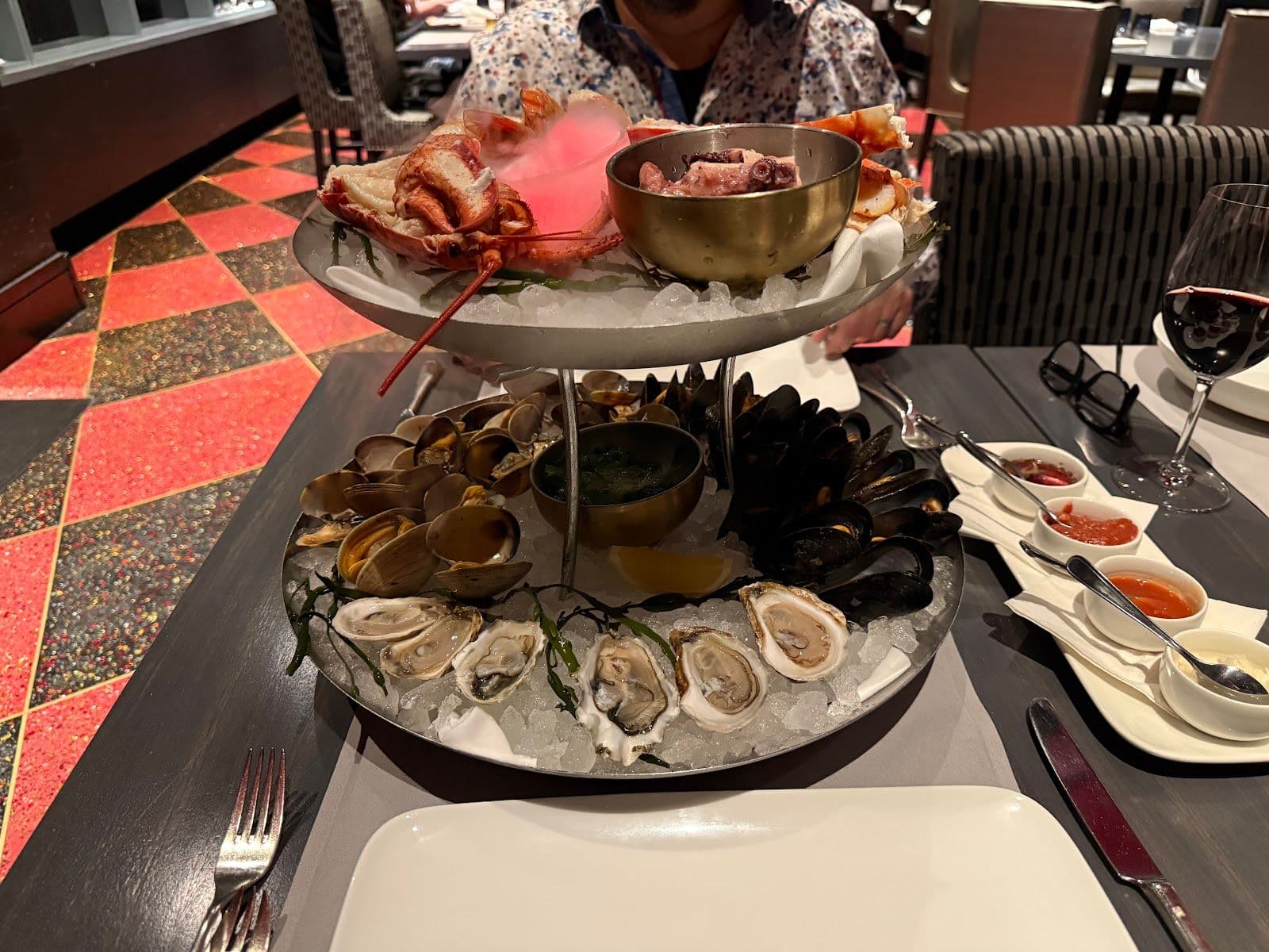 Restaurant manager reviewing Google guest feedback on a tablet at 21 Club Steak and Seafood
