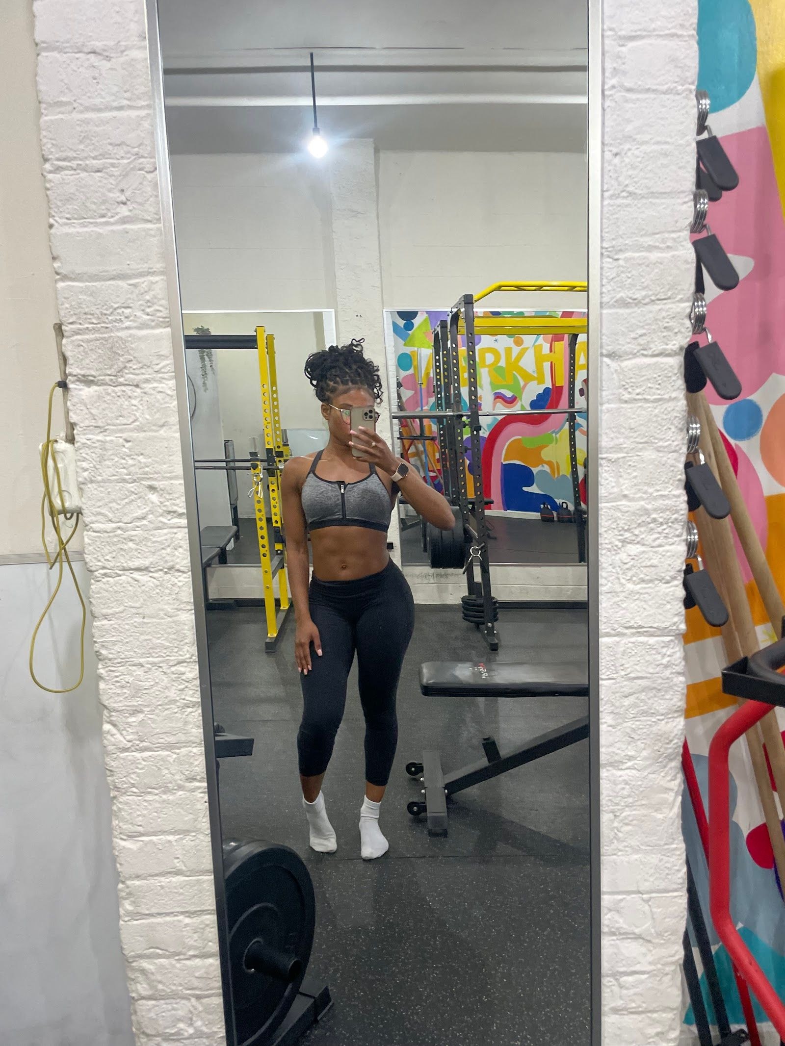 Personal trainer checking Google reviews on her phone at the studio