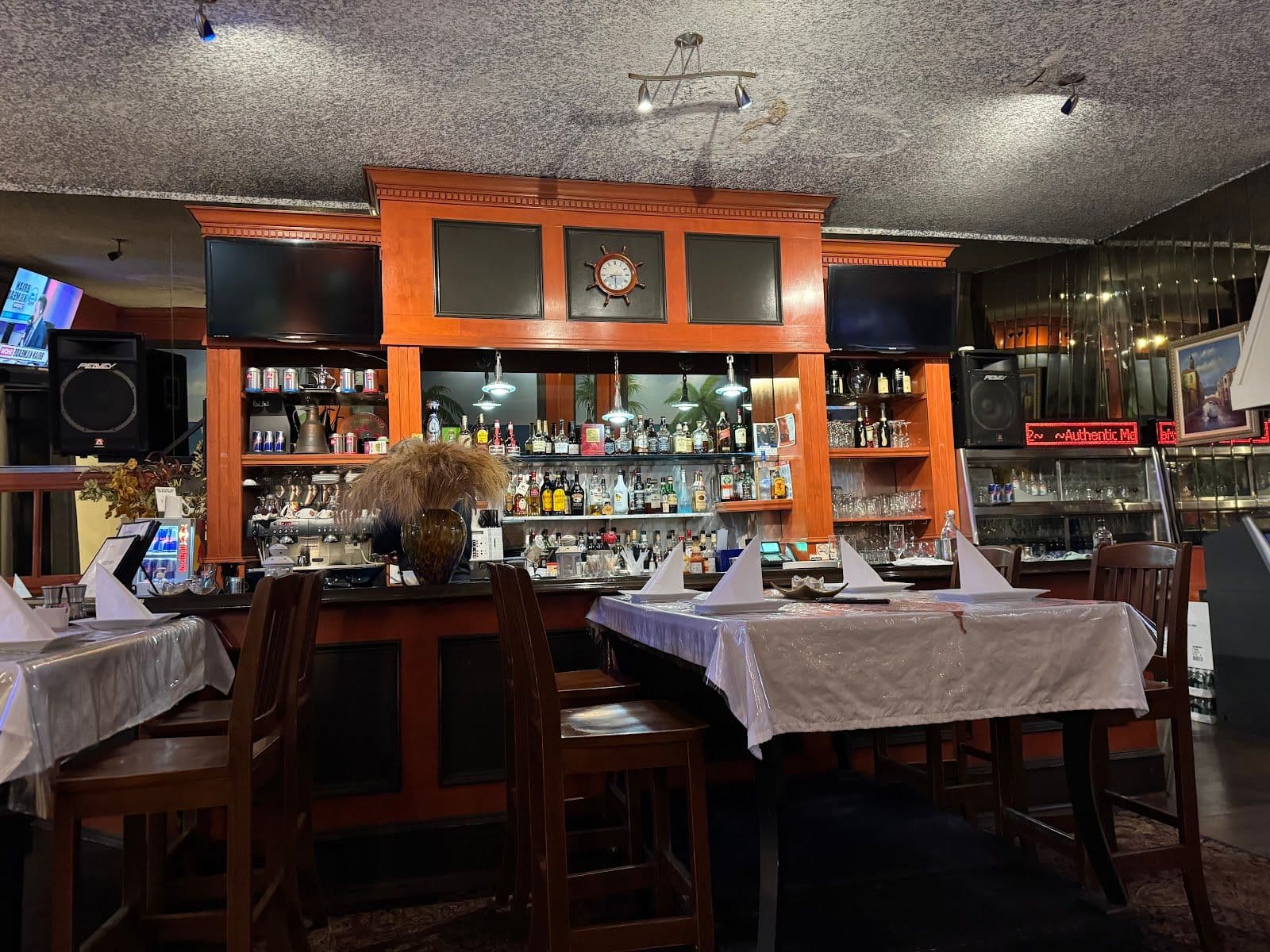 Restaurant team at Cafe Nautica reviewing guest feedback on a tablet near the dining room