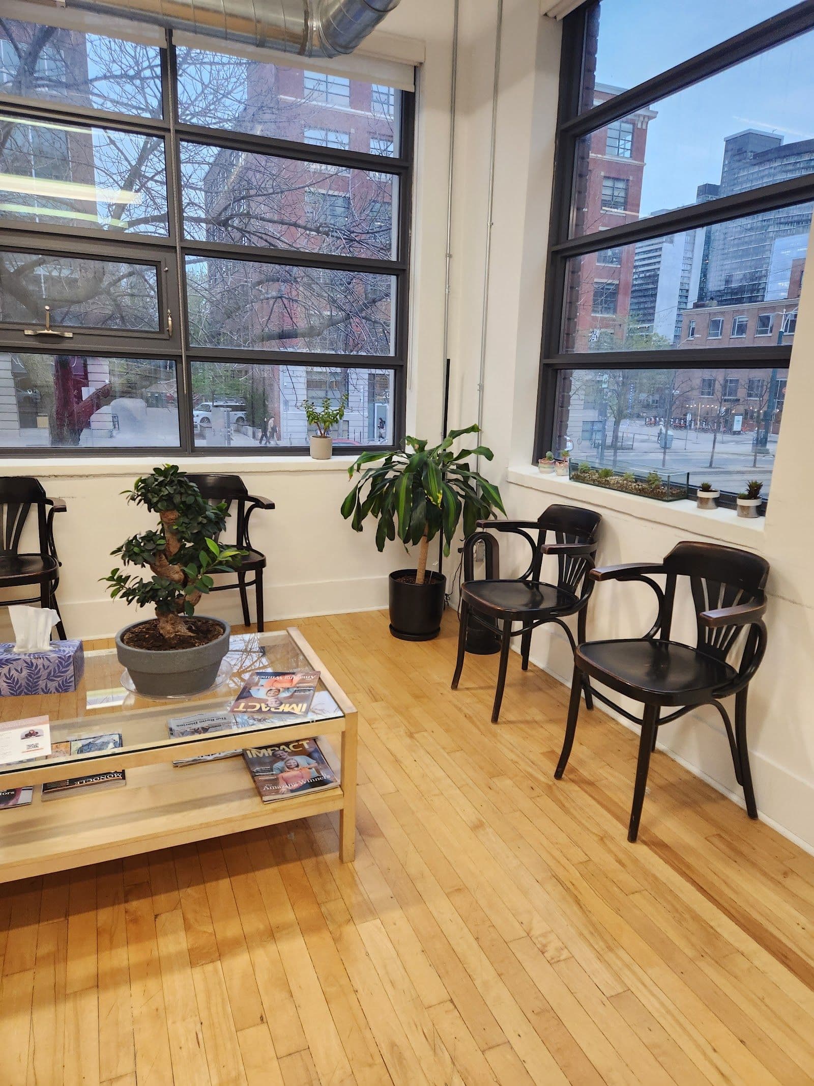 Imprint Pilates Toronto studio owner and team reviewing member feedback and Google reviews on a tablet at the front desk