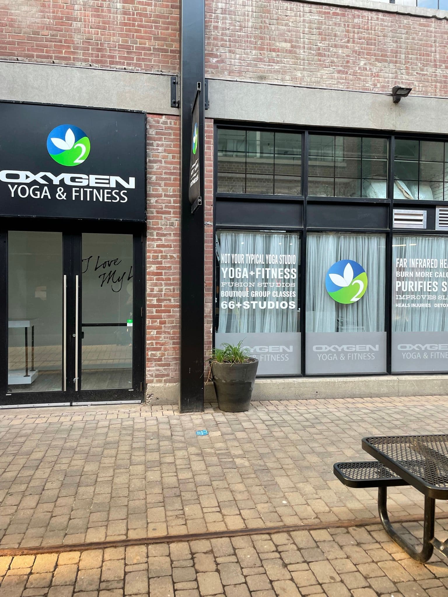 Oxygen Yoga and Fitness Liberty Village owner and staff reviewing member feedback together at the studio front desk