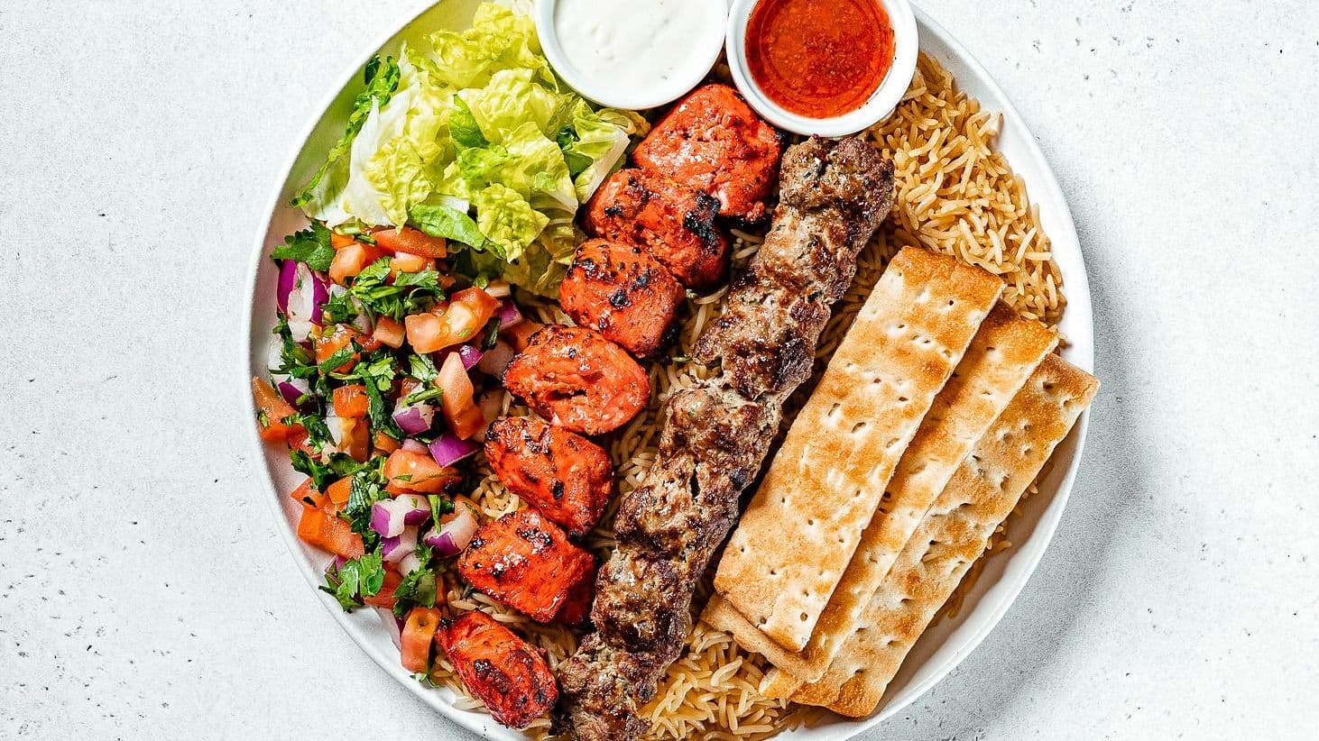 The Kabob Guys team reviewing guest feedback on a dashboard at their Toronto restaurant
