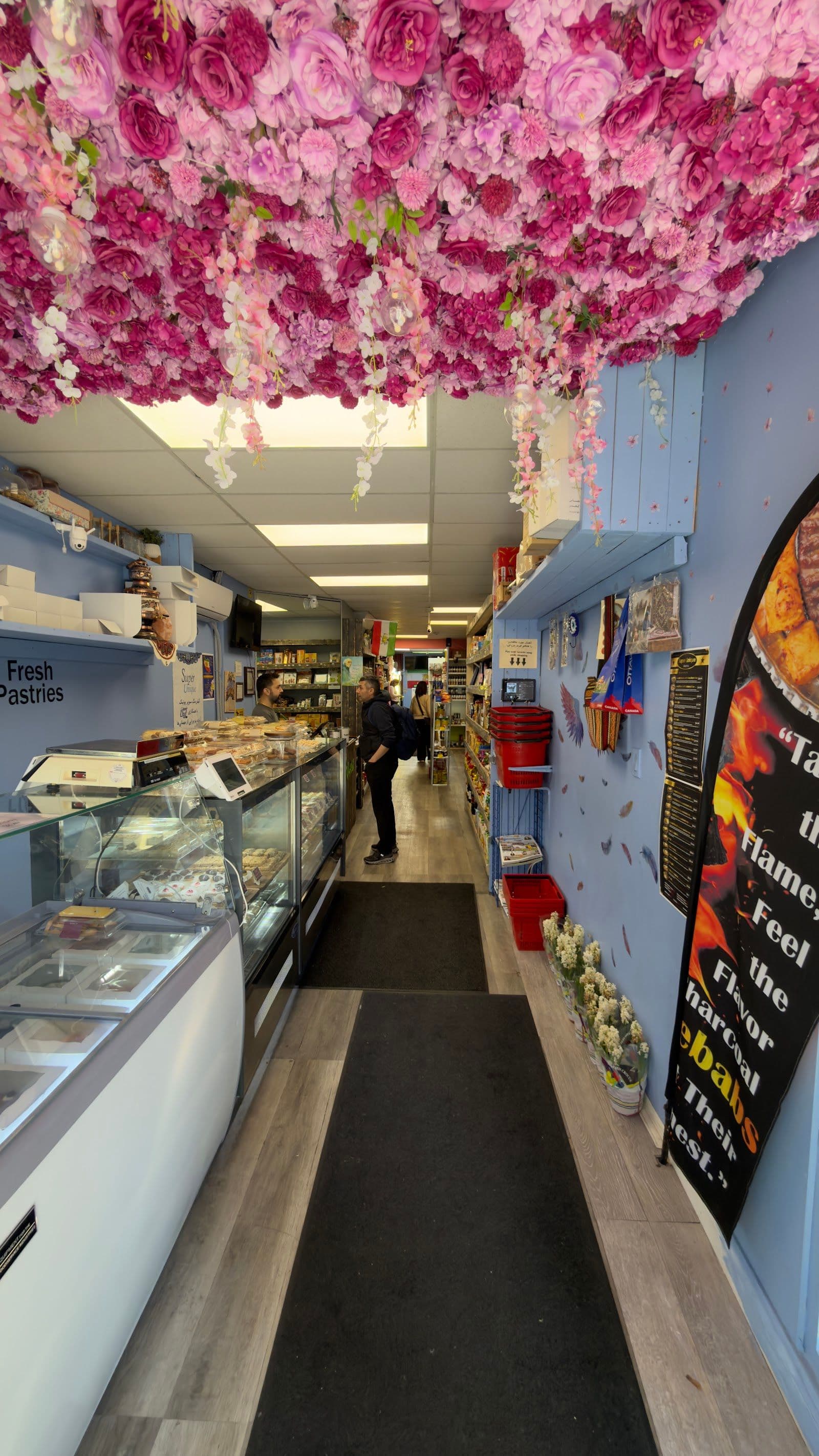 Super Unique owner and team reviewing guest feedback together at the counter of their Persian market and takeout shop
